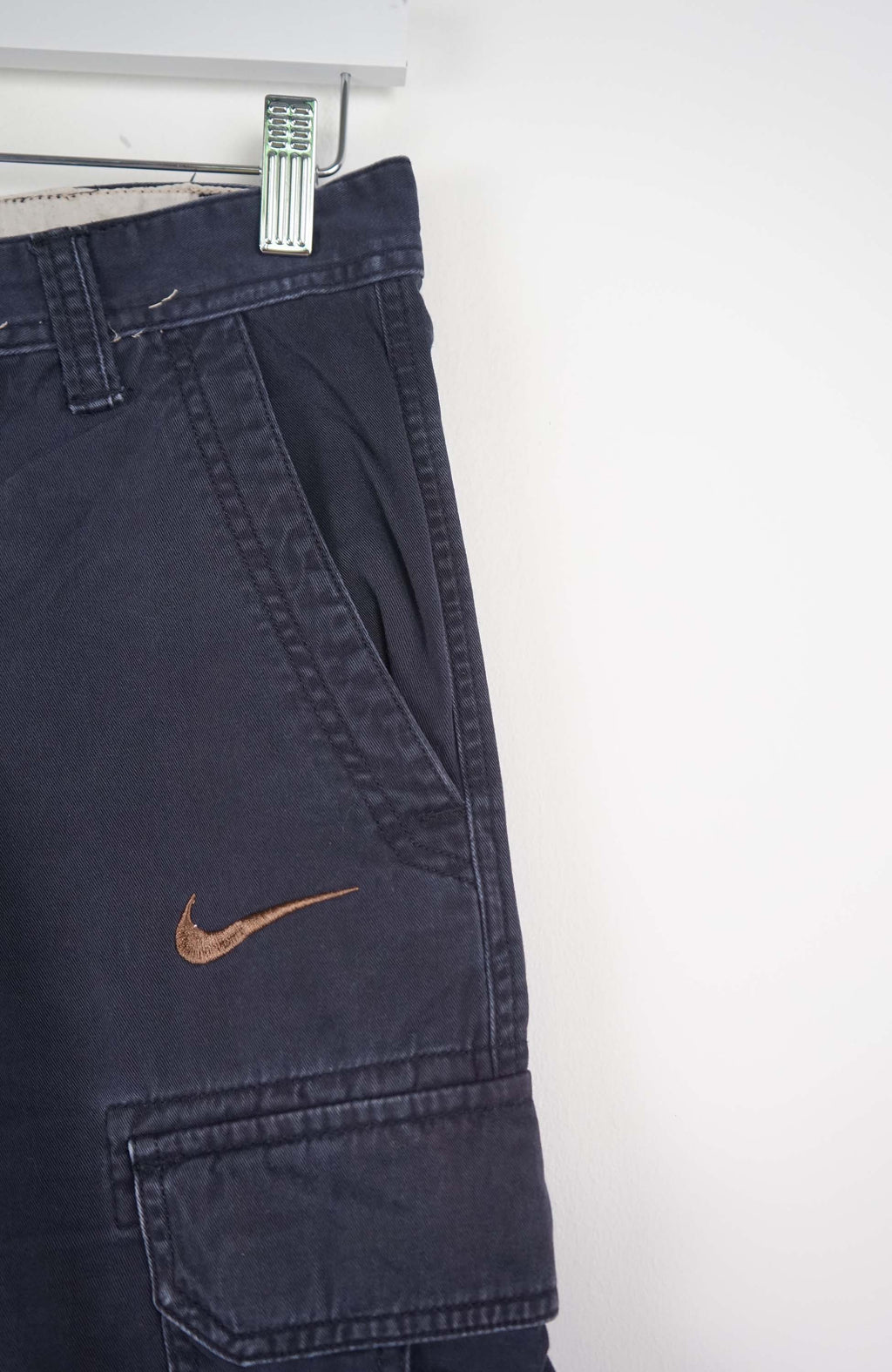 Navy blue cargo shorts with Nike logo on a white background