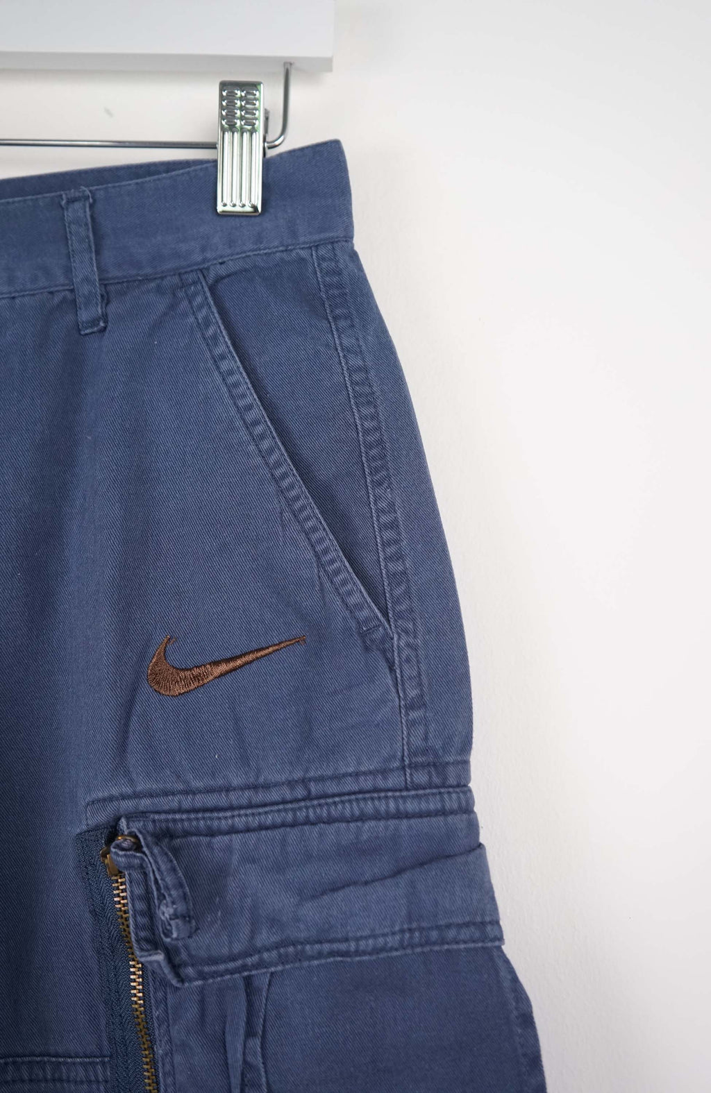 Blue cargo shorts with a brand logo on a white background