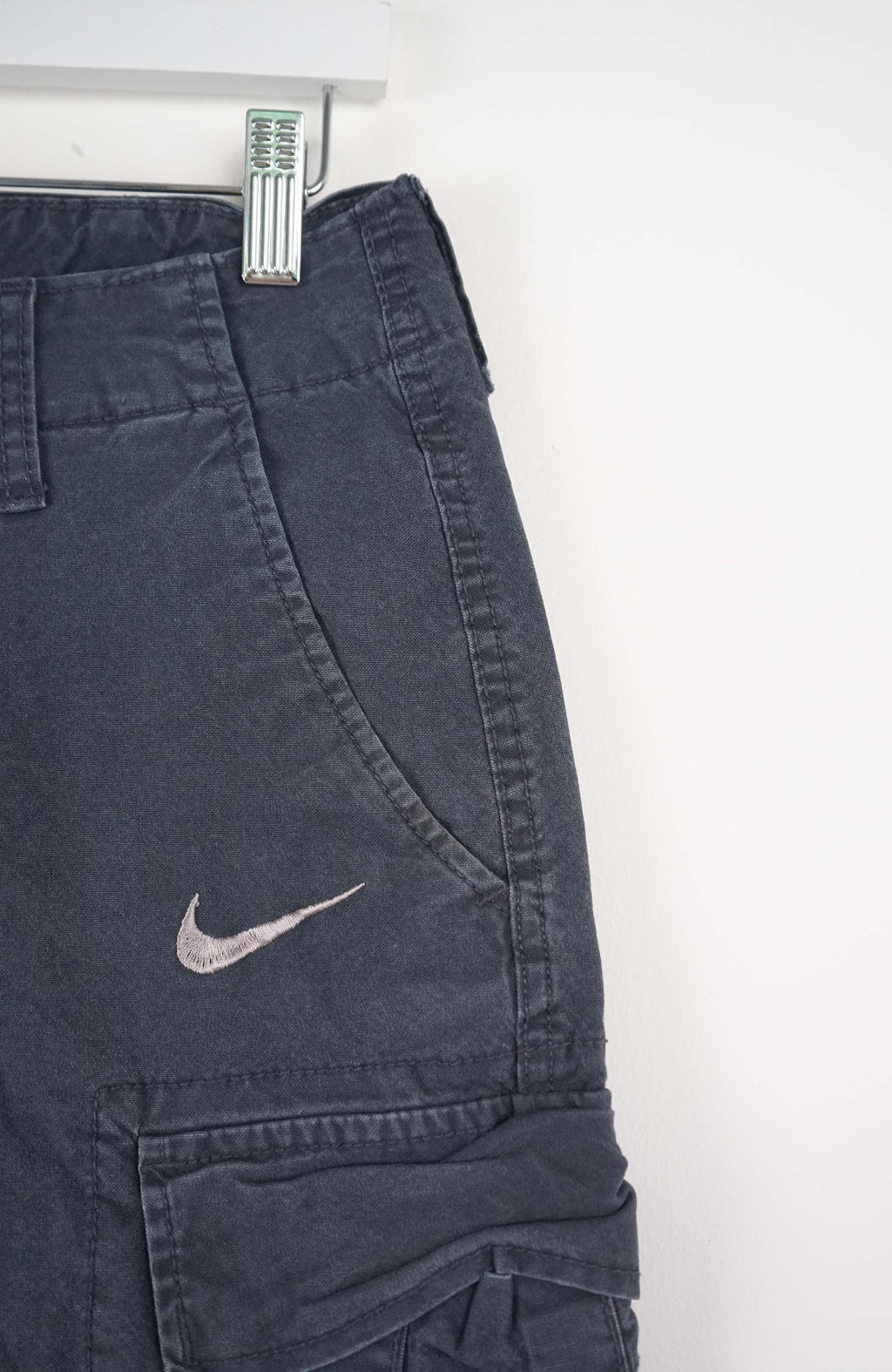 Blue cargo shorts with a Nike logo on a white background