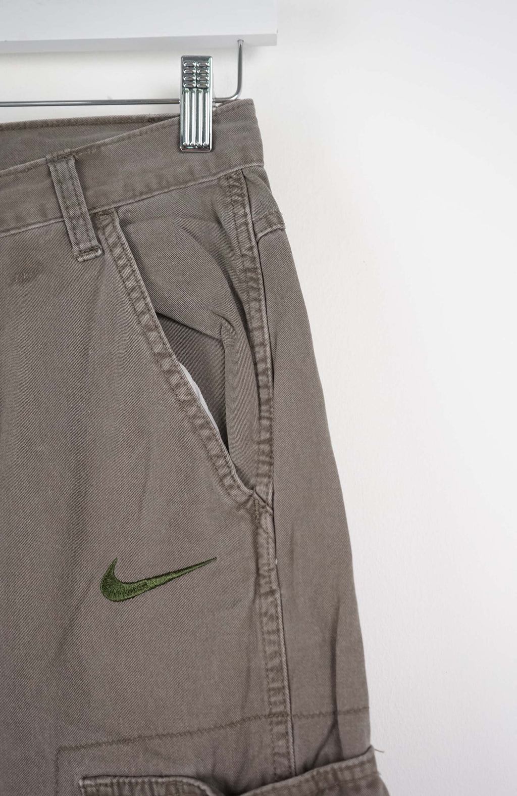 Gray cargo shorts with a Nike logo on a white background