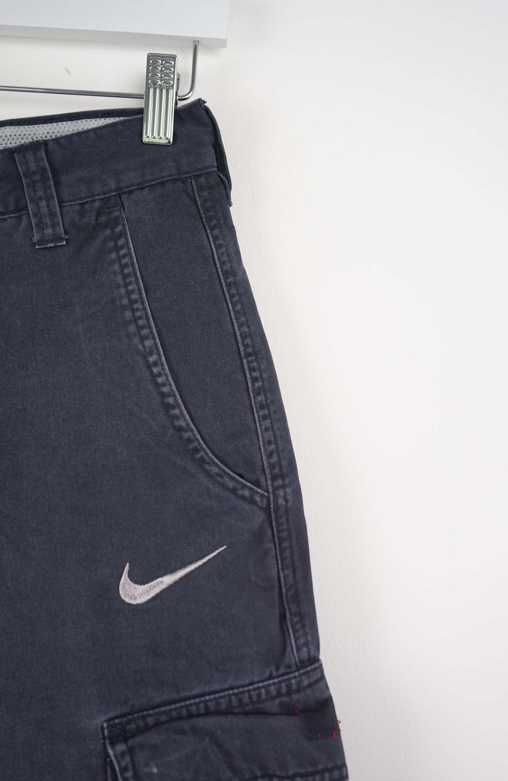 Blue cargo shorts with a Nike logo on a white background