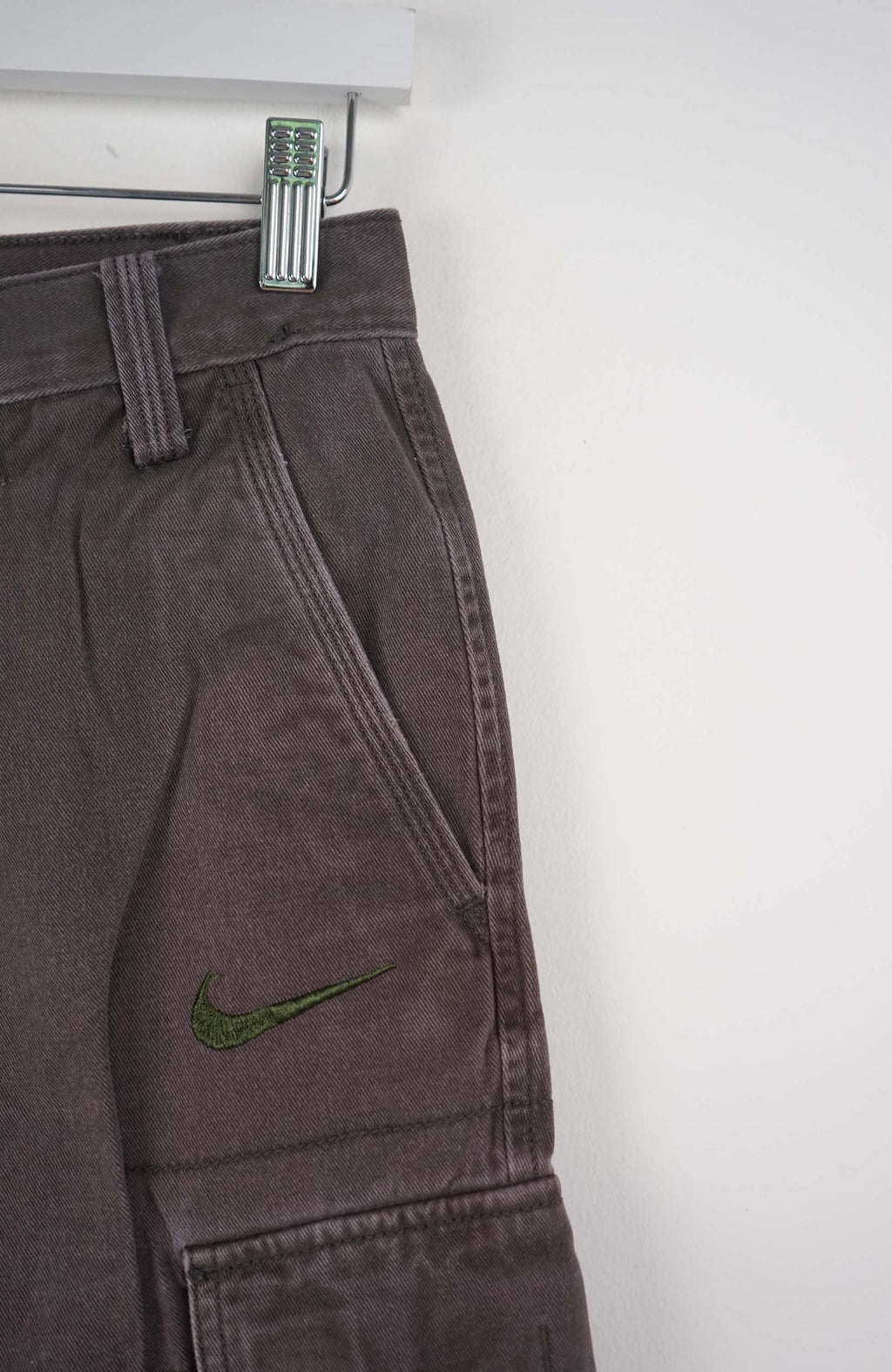 Gray cargo shorts with a Nike logo on a white background