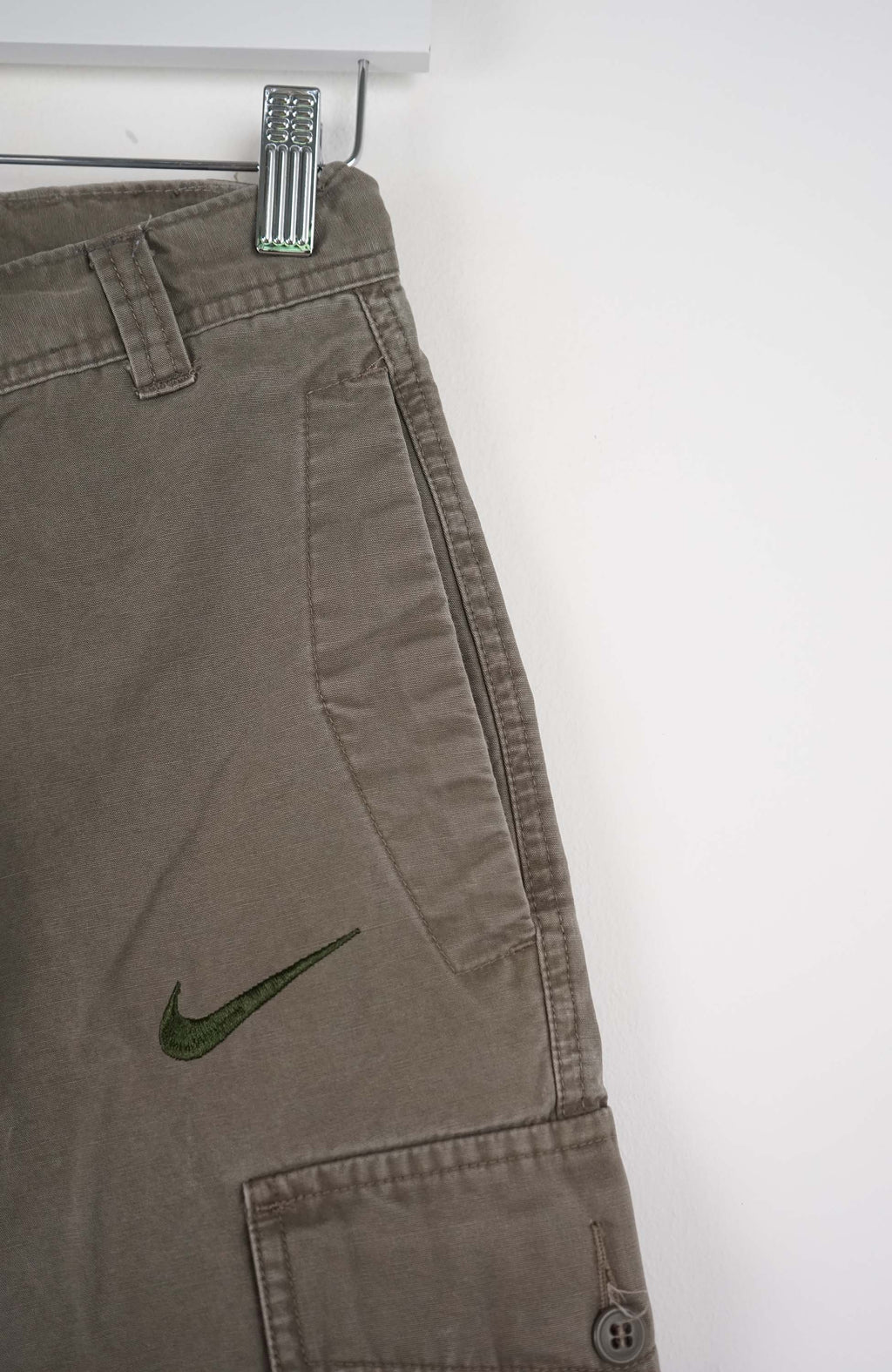 Brown cargo shorts with a Nike logo on a white background
