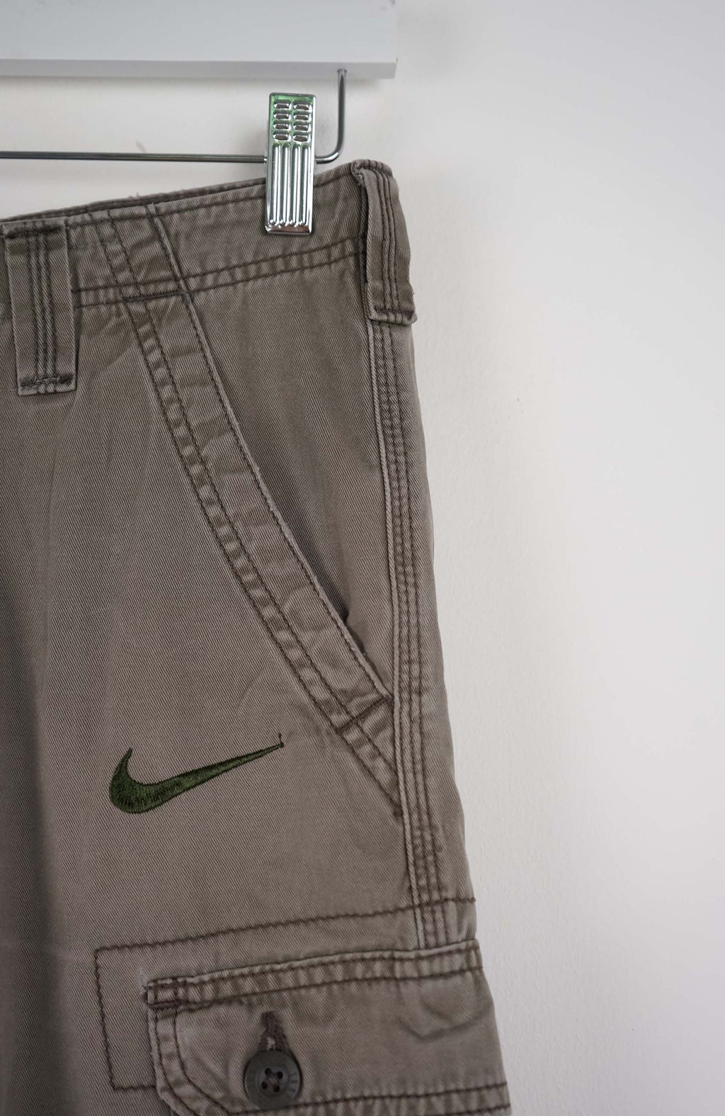 Gray cargo shorts with a Nike logo on a white background