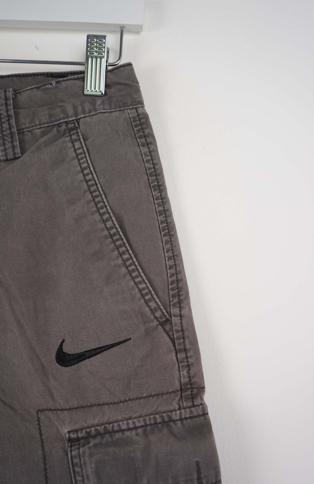 Gray cargo shorts with a Nike logo on a white background