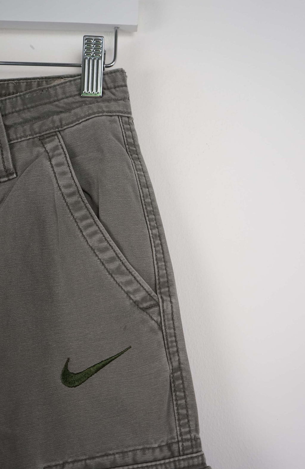 Gray cargo shorts with a Nike logo on a white background