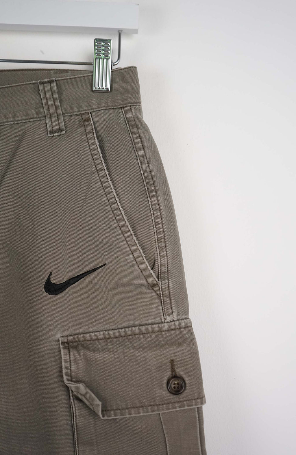 Gray cargo shorts with a Nike logo on a white background