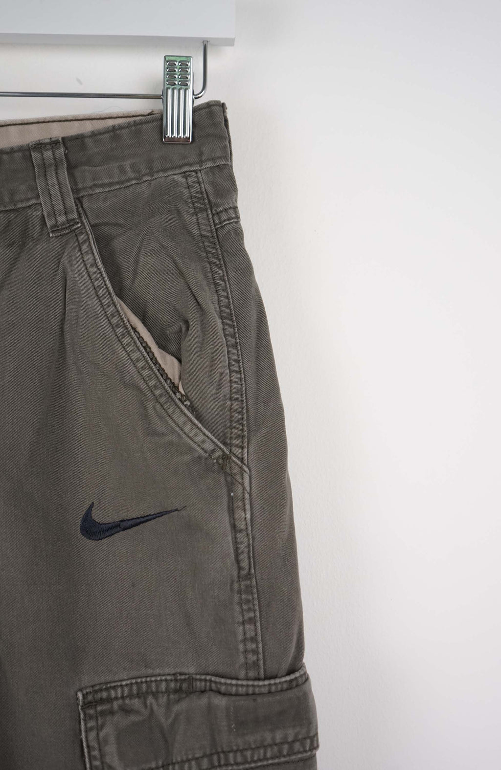 Gray cargo shorts with a Nike logo on a white background