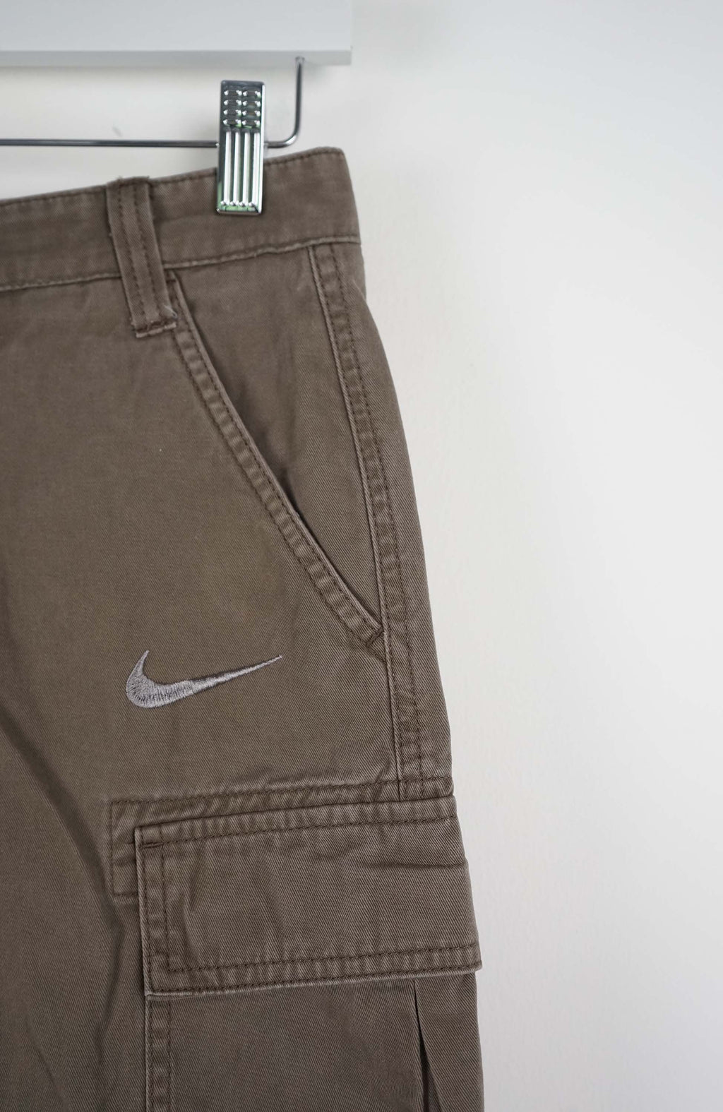 Brown cargo shorts with Nike logo on a white background