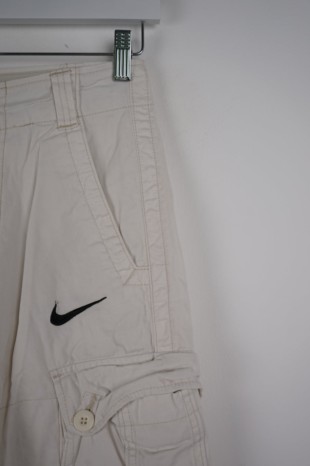 Light gray cargo pants with a Nike logo on a white background