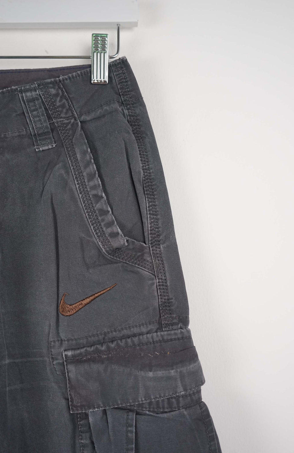 Gray cargo shorts with a Nike logo on a white background
