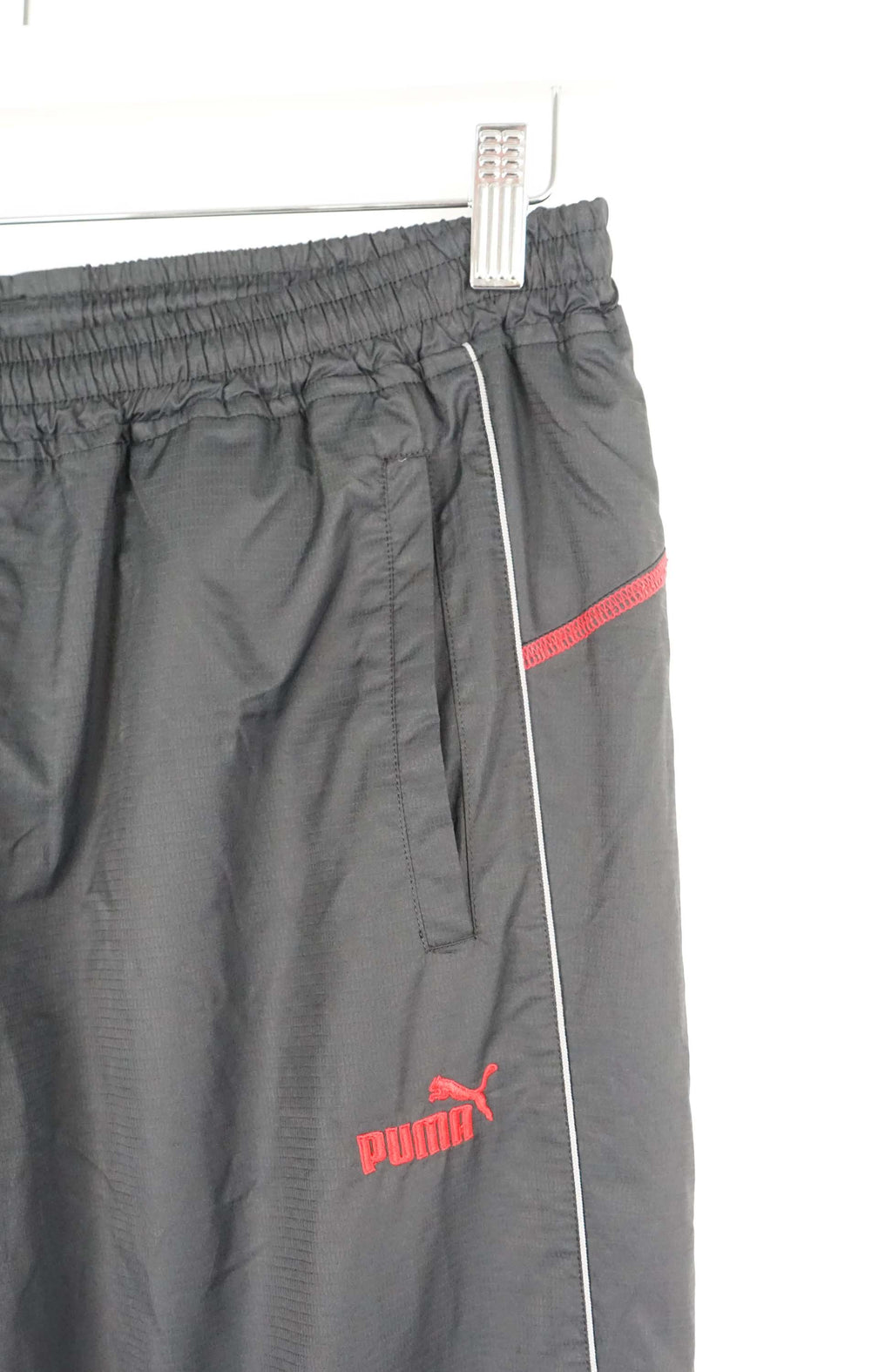 Black pants with red accents on a white background