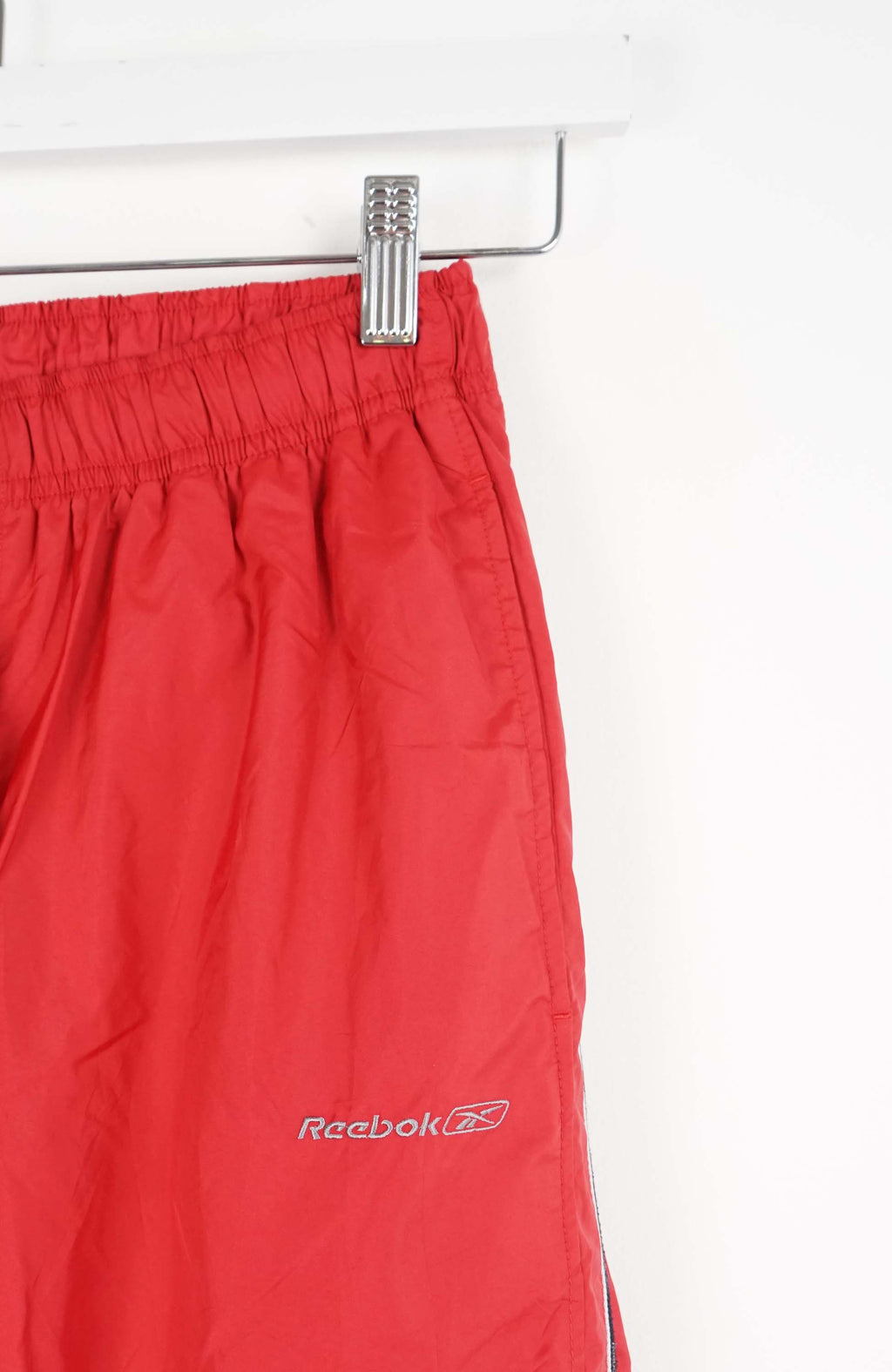 Red pants with a side stripe on a white background