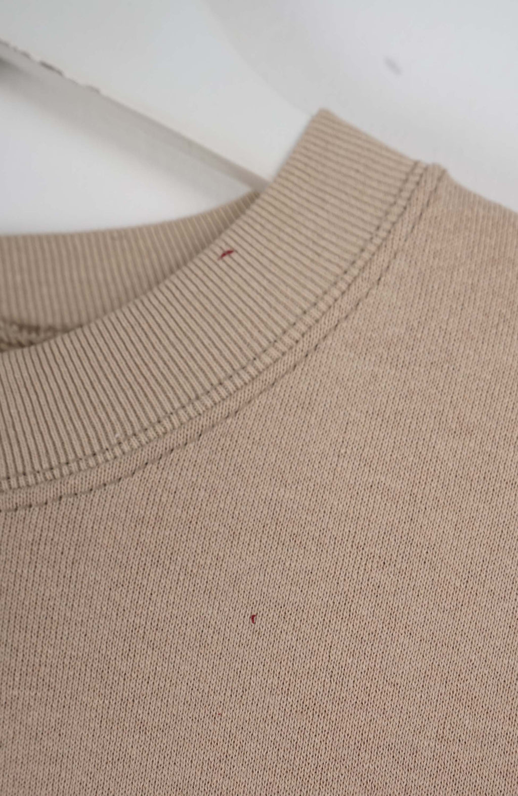 Beige sweatshirt with Tommy Gear logo on a white background