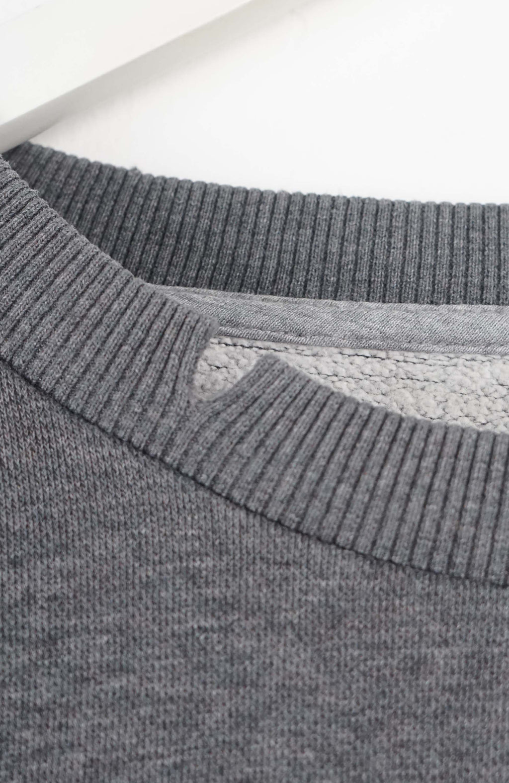 Gray sweatshirt with a Nike logo on a white background