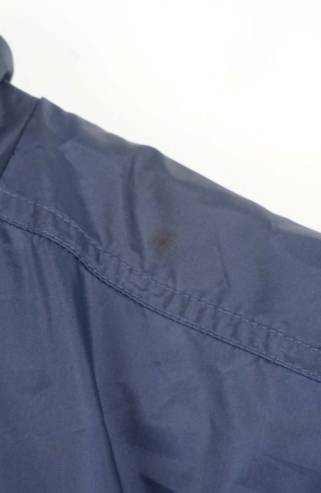 Blue jacket with a logo and text on a white background