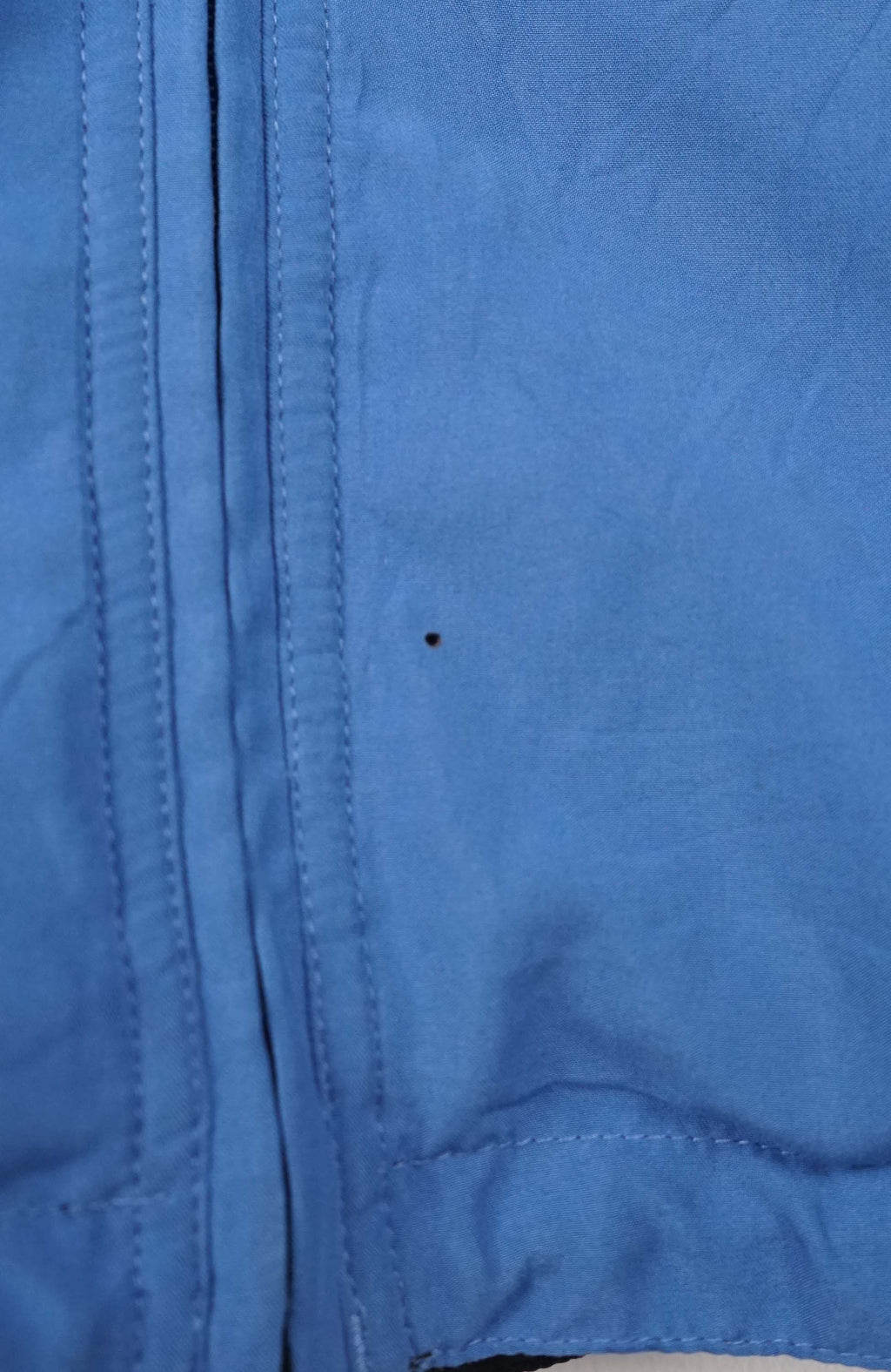 Blue jacket with a brand logo on a white background