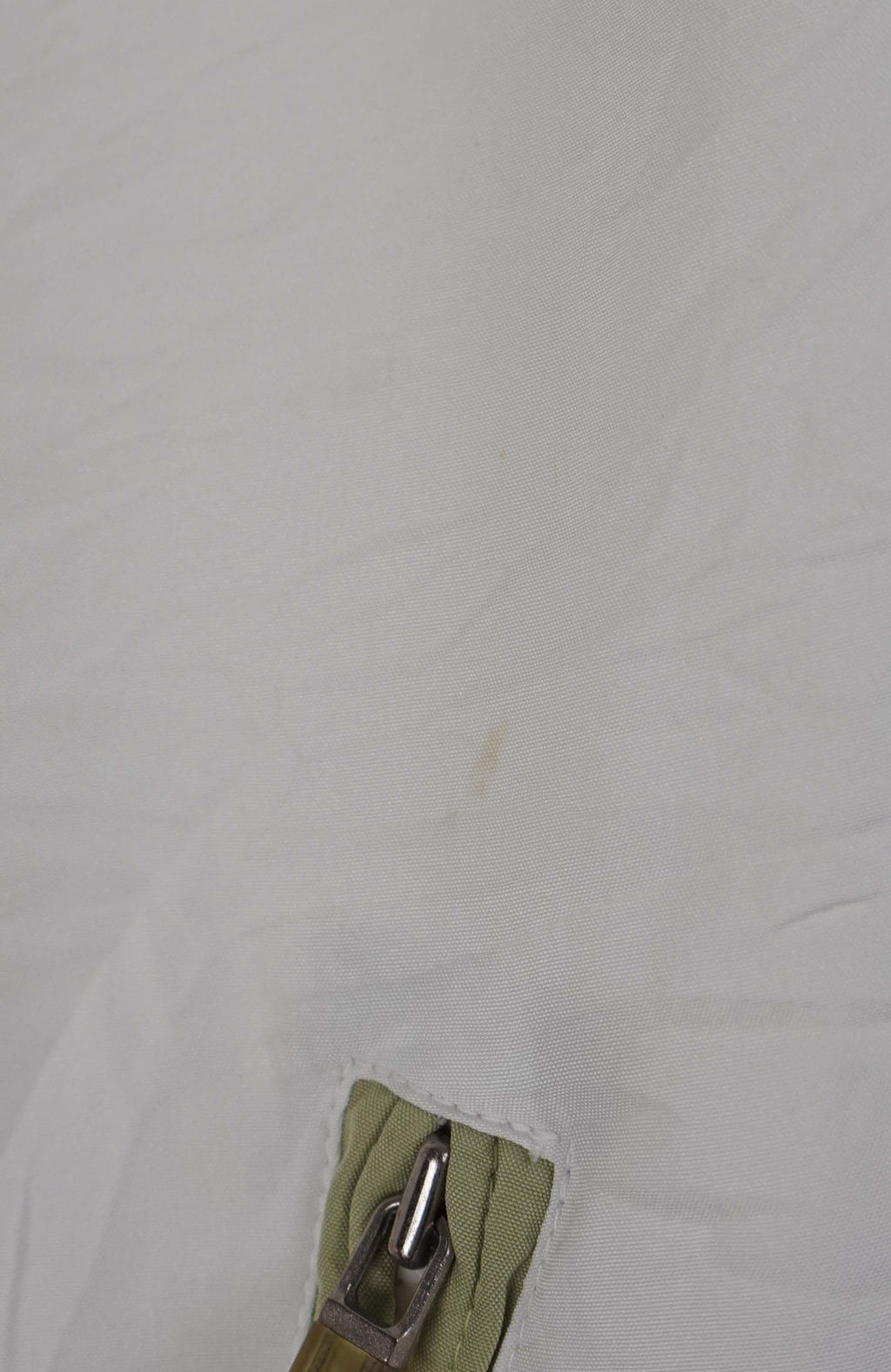 White jacket with green accents on a white background