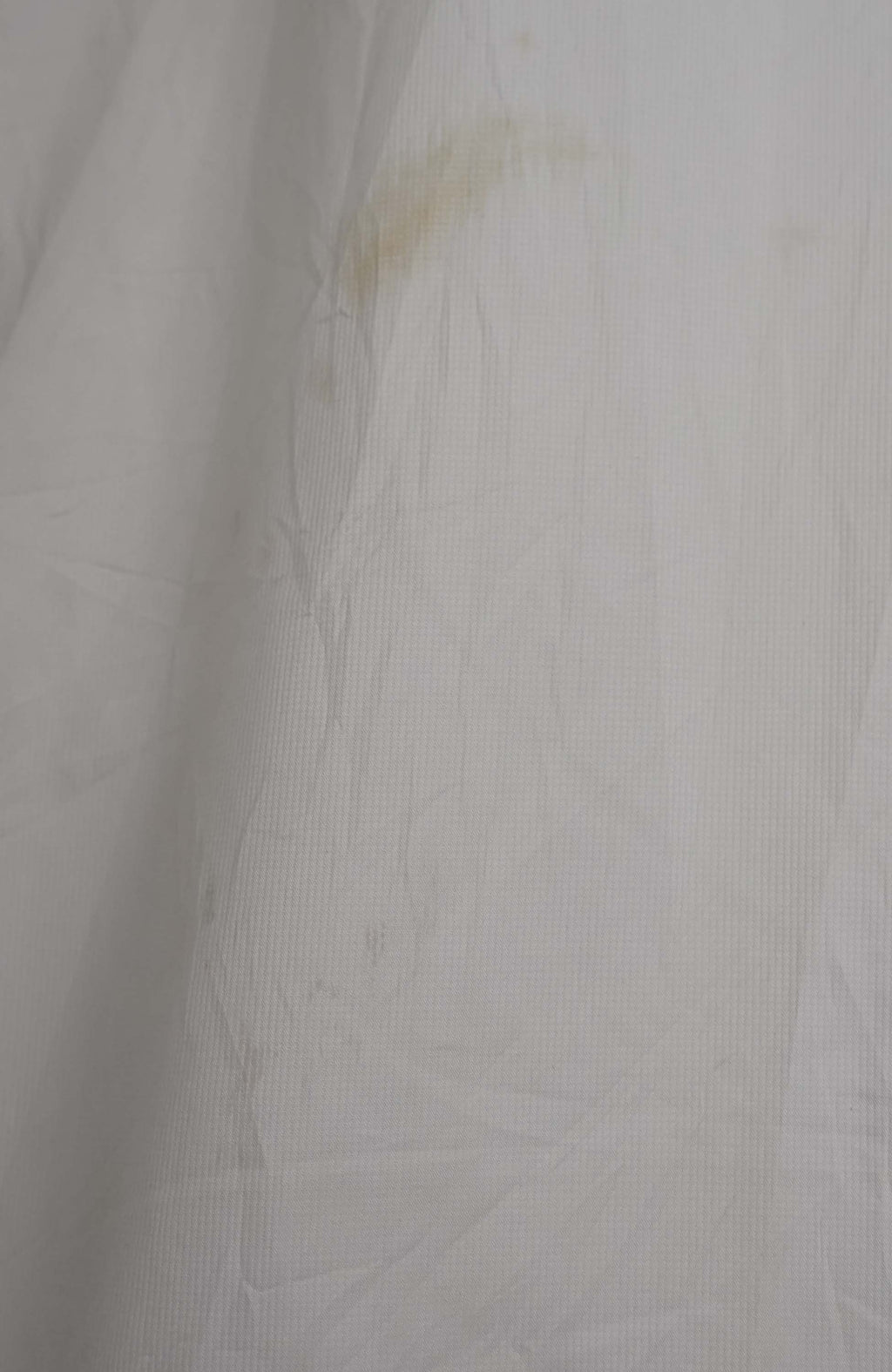 Beige sweater on a hanger against a white background