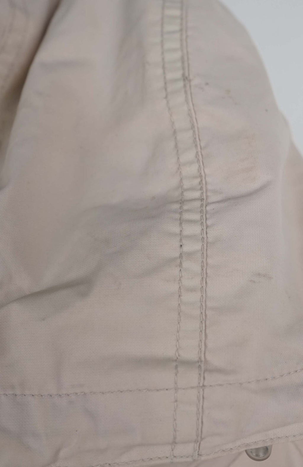 Beige and red jacket with a hood on a white background