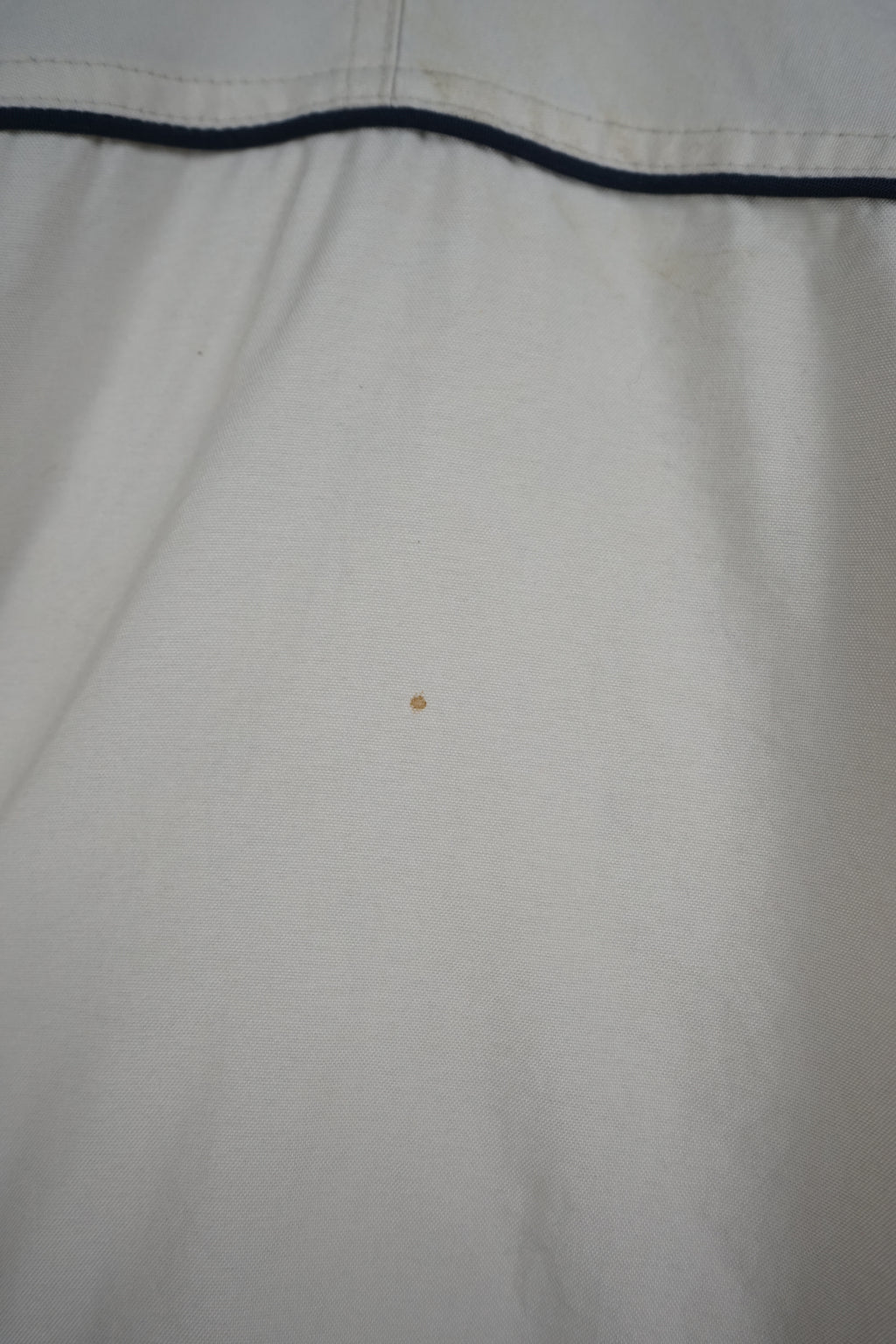 Beige winter coat with black accents on a white background