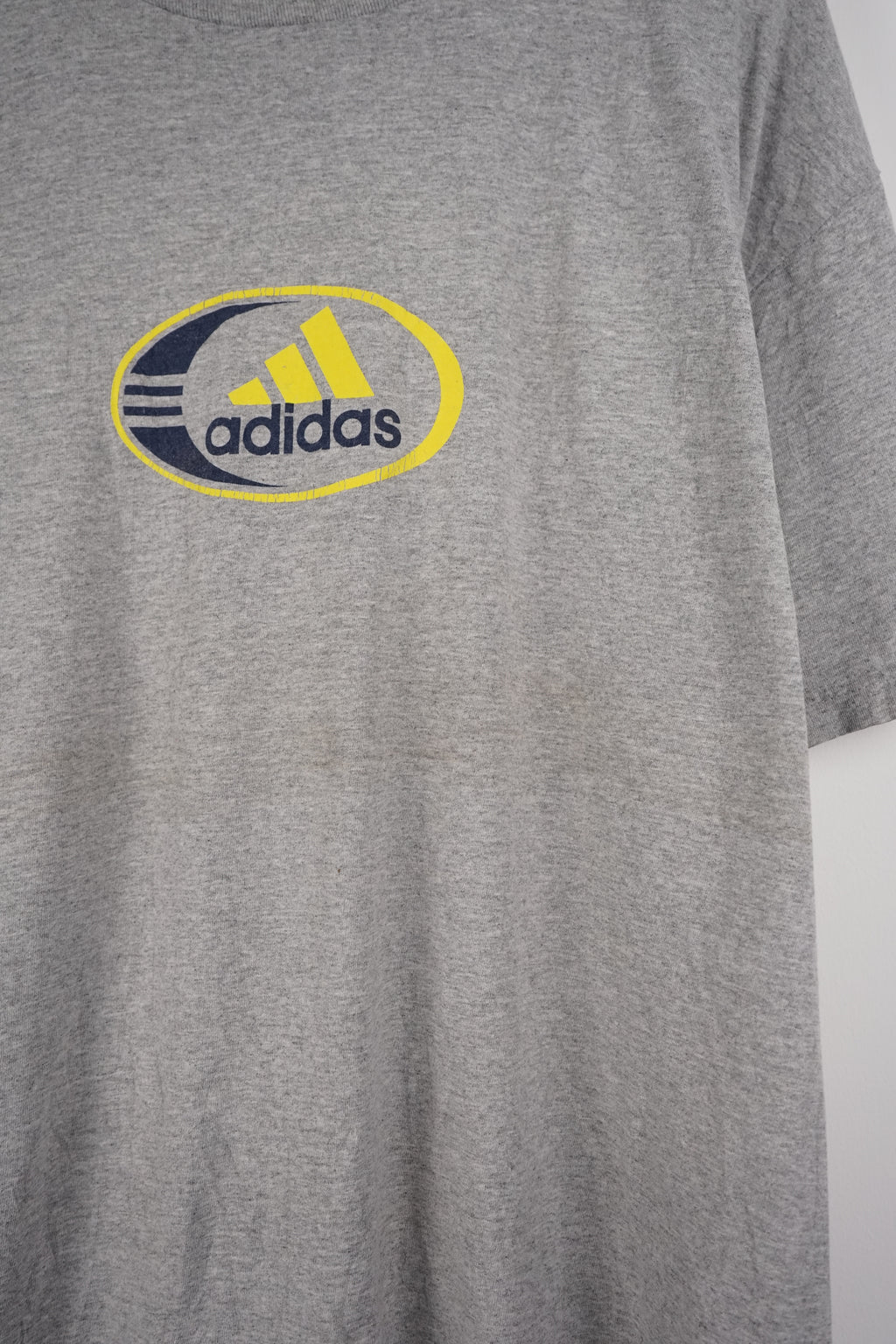Gray t-shirt with Adidas logo on a white background