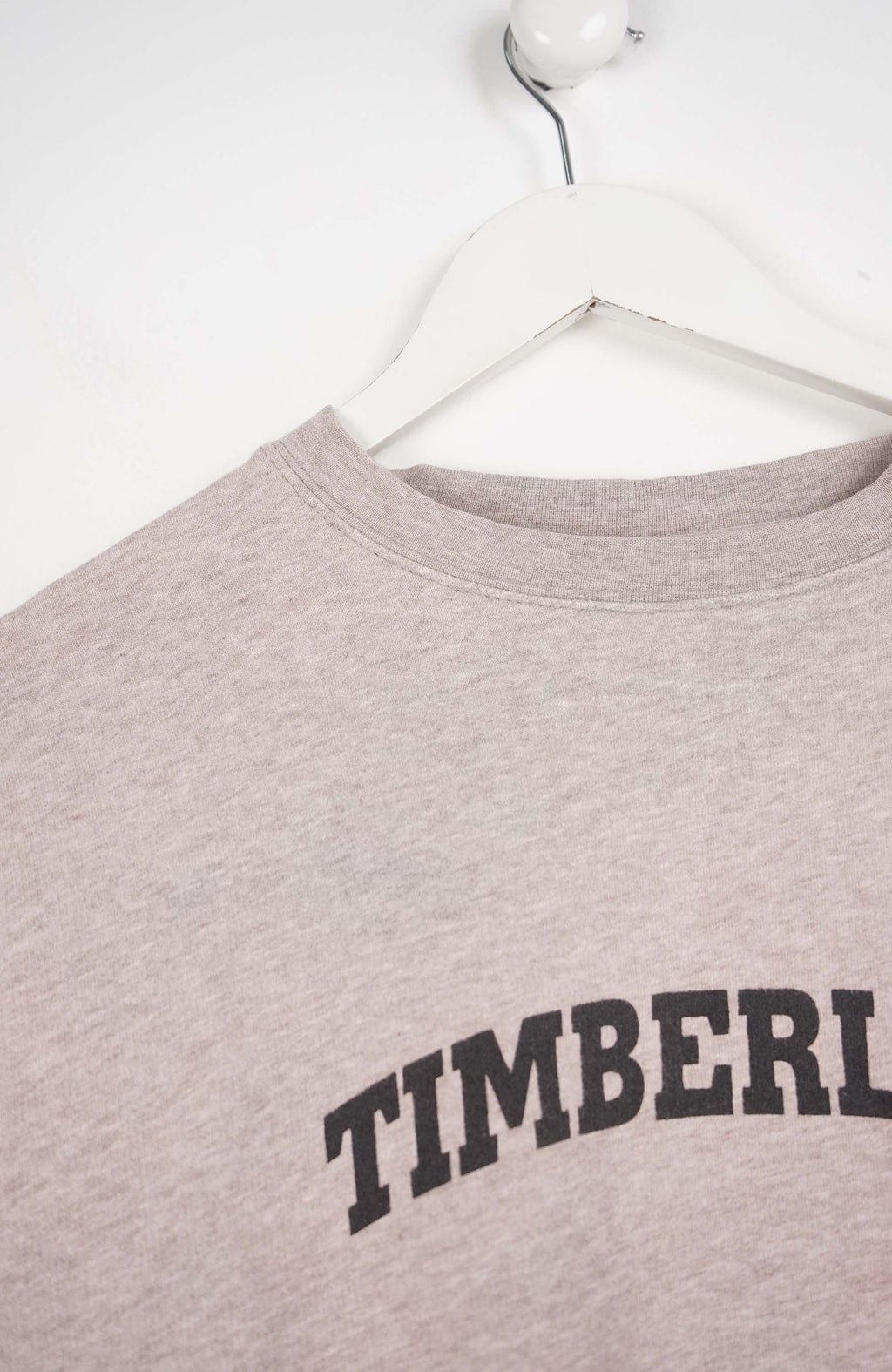 Gray sweatshirt with 'TIMBERLAND' text on a white background