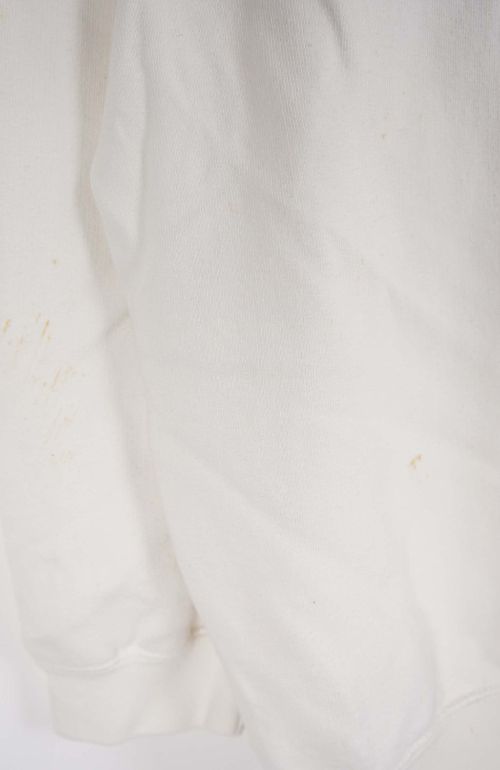 White sweatshirt with a logo on a hanger against a white background