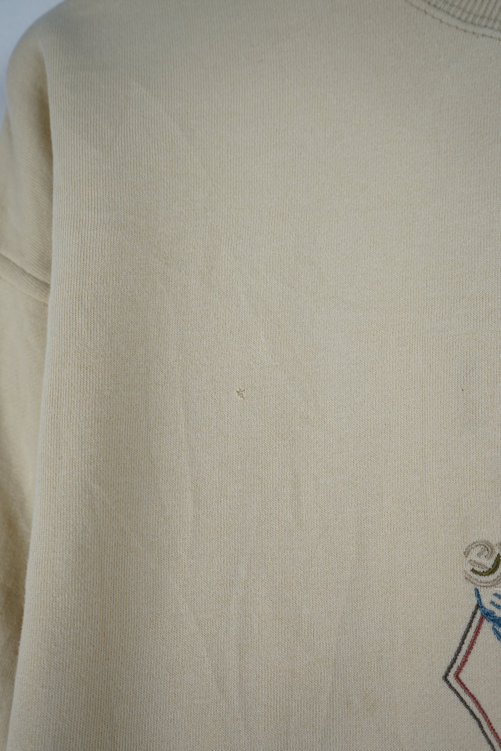 Beige sweatshirt with a decorative pattern on a white background