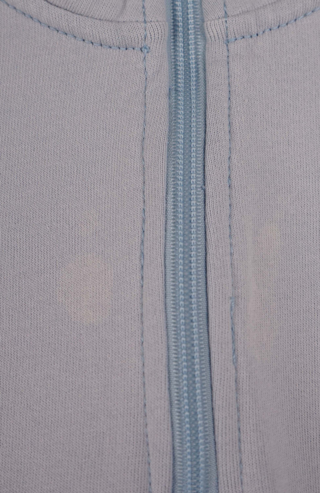 Light blue pullover with a quarter zip on a white background