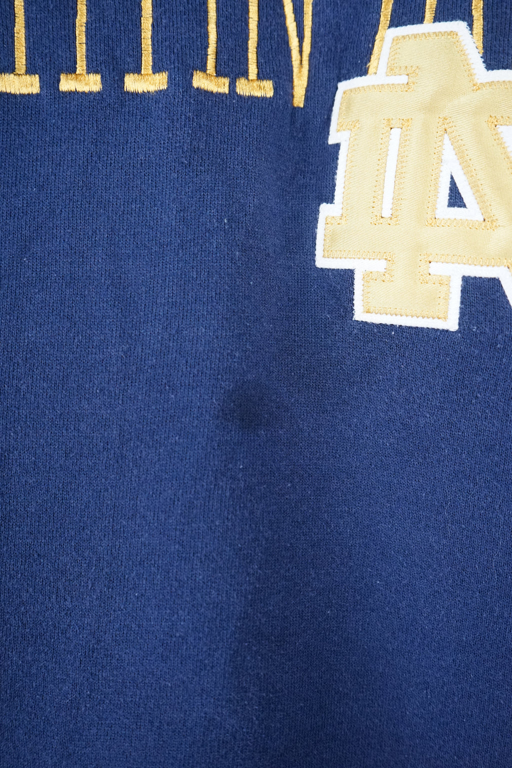 Navy blue sweatshirt with 'Notre Dame Fighting Irish' text and logo on a white background
