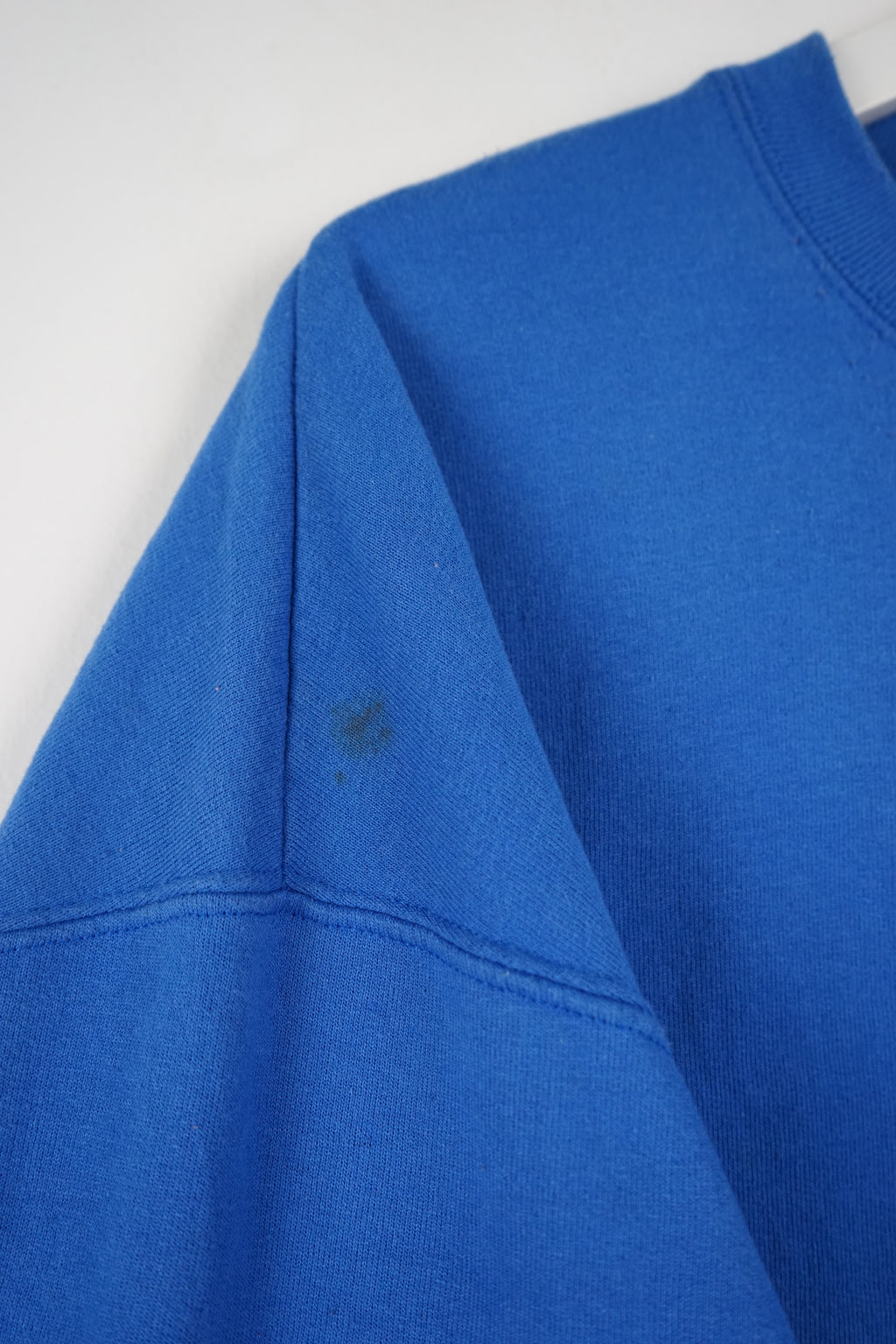 Blue sweatshirt with Champion logo on a white background