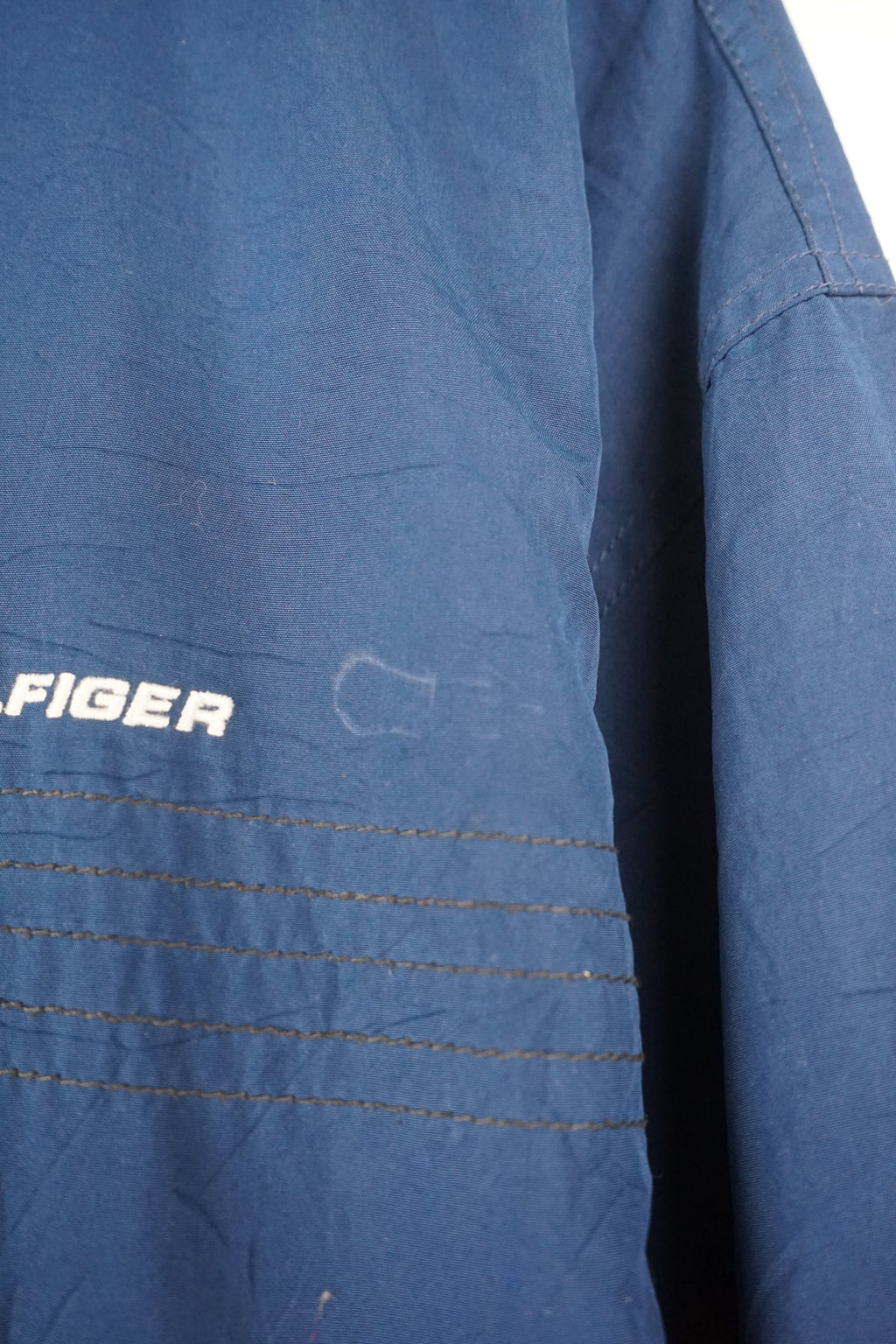Blue jacket with a brand logo on a white background