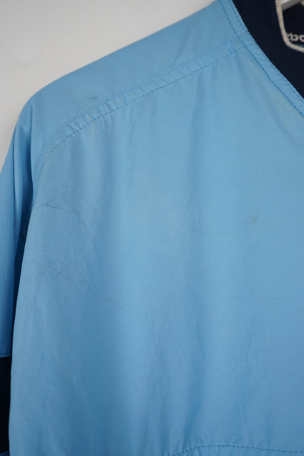 Light blue long-sleeve shirt with dark blue accents on a white background