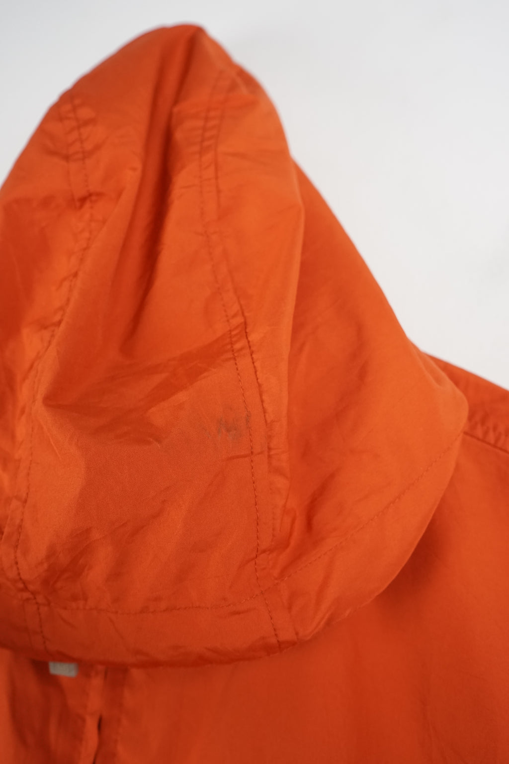 Orange jacket with a black stripe on a white background
