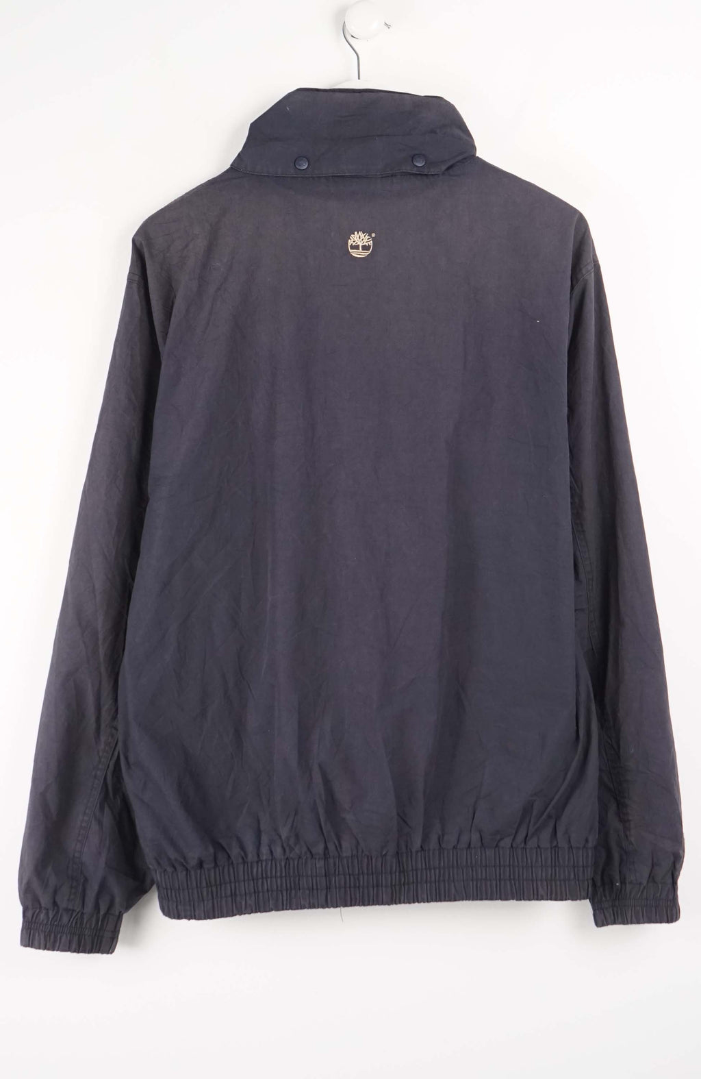 Dark jacket with Timberland logo on a white background
