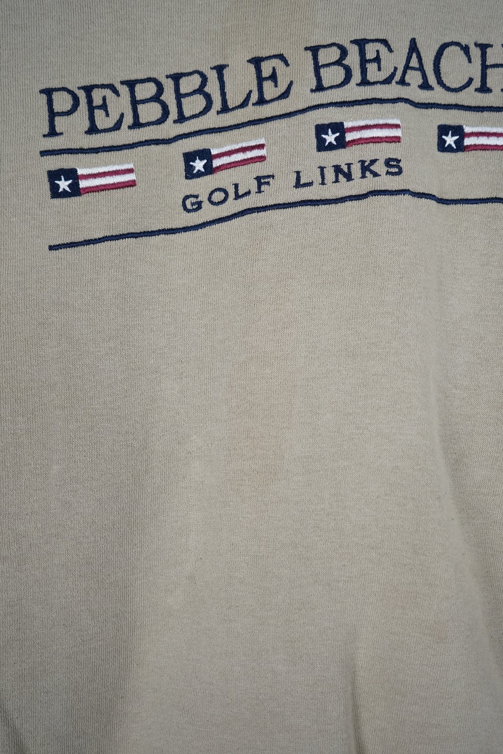 Beige sweatshirt with 'Pebble Beach Golf Links' text on a white background