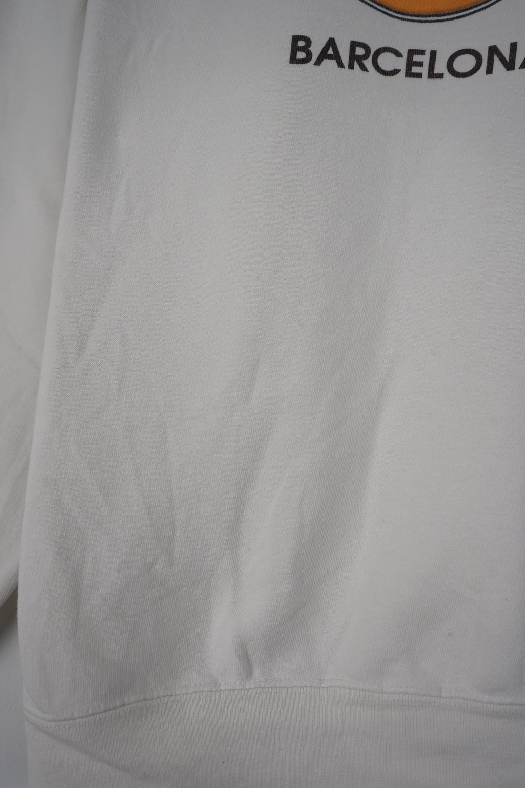 White sweatshirt with Hard Rock Cafe Barcelona logo on a white background