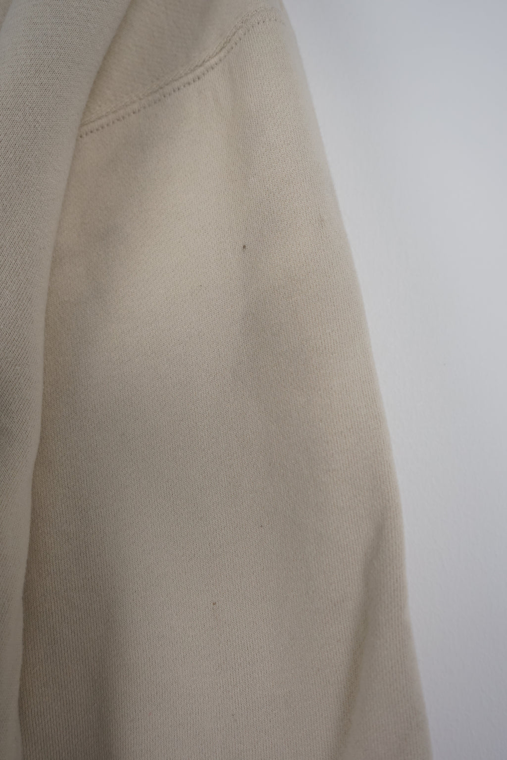 Beige sweatshirt with Playboy graphic on a white background