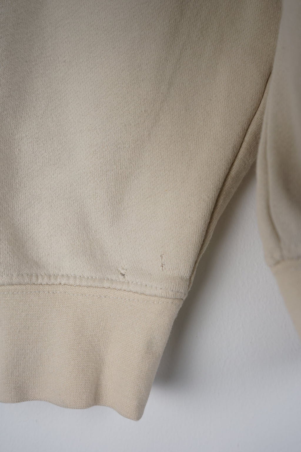 Beige sweatshirt with Playboy graphic on a white background