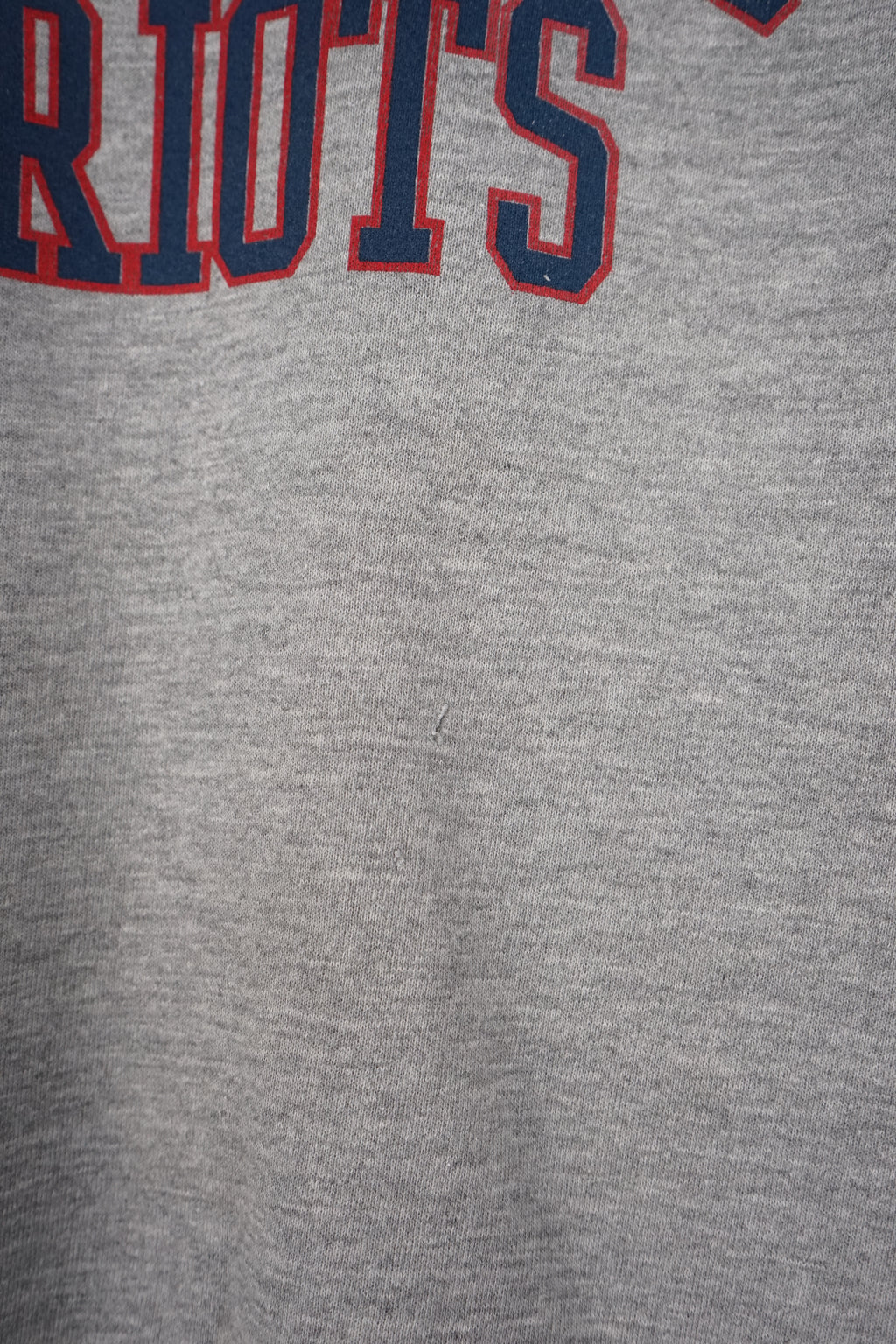 Gray sweatshirt with 'New England Patriots' text on a white background