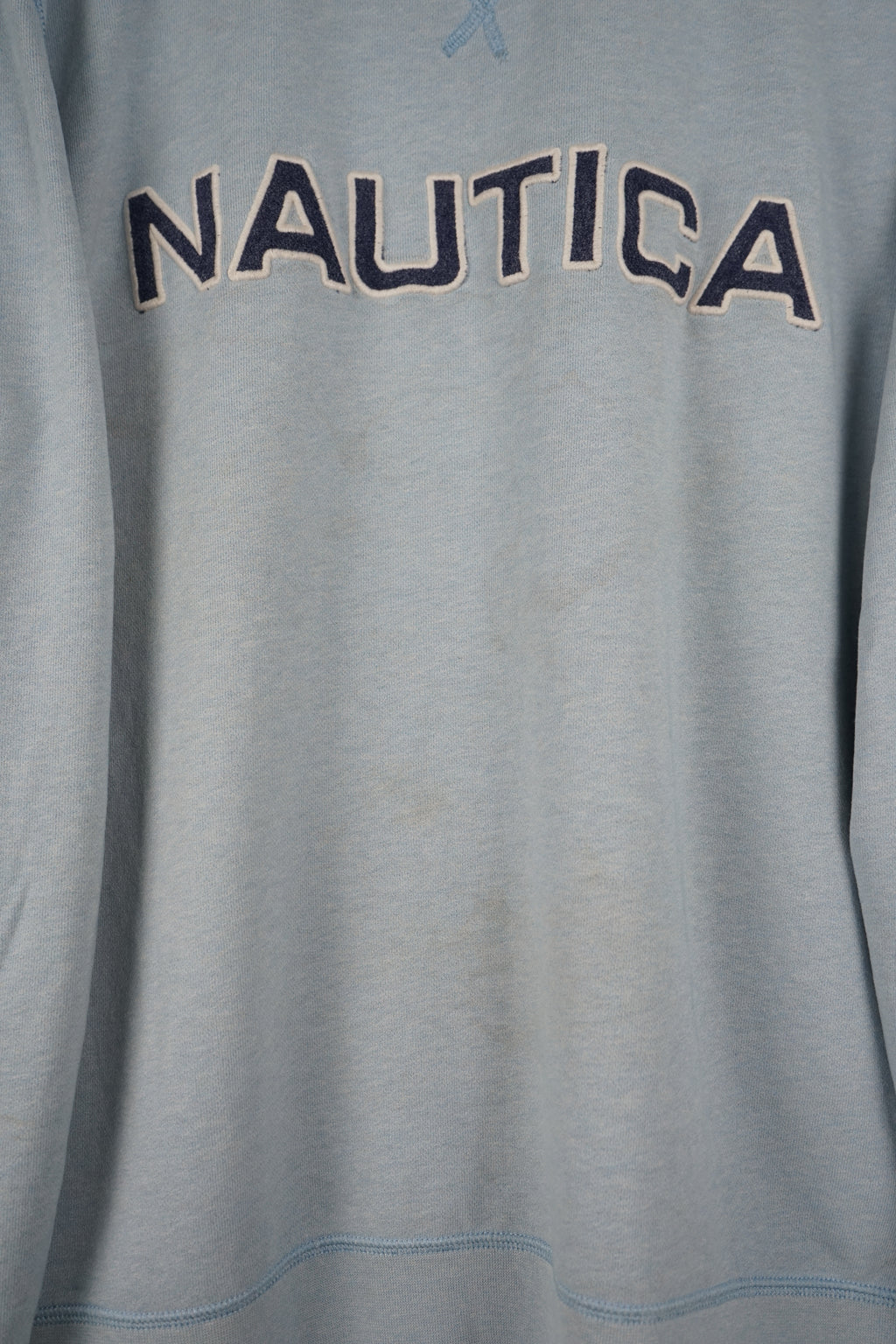 Light blue Nautica sweatshirt on a white hanger against a white background