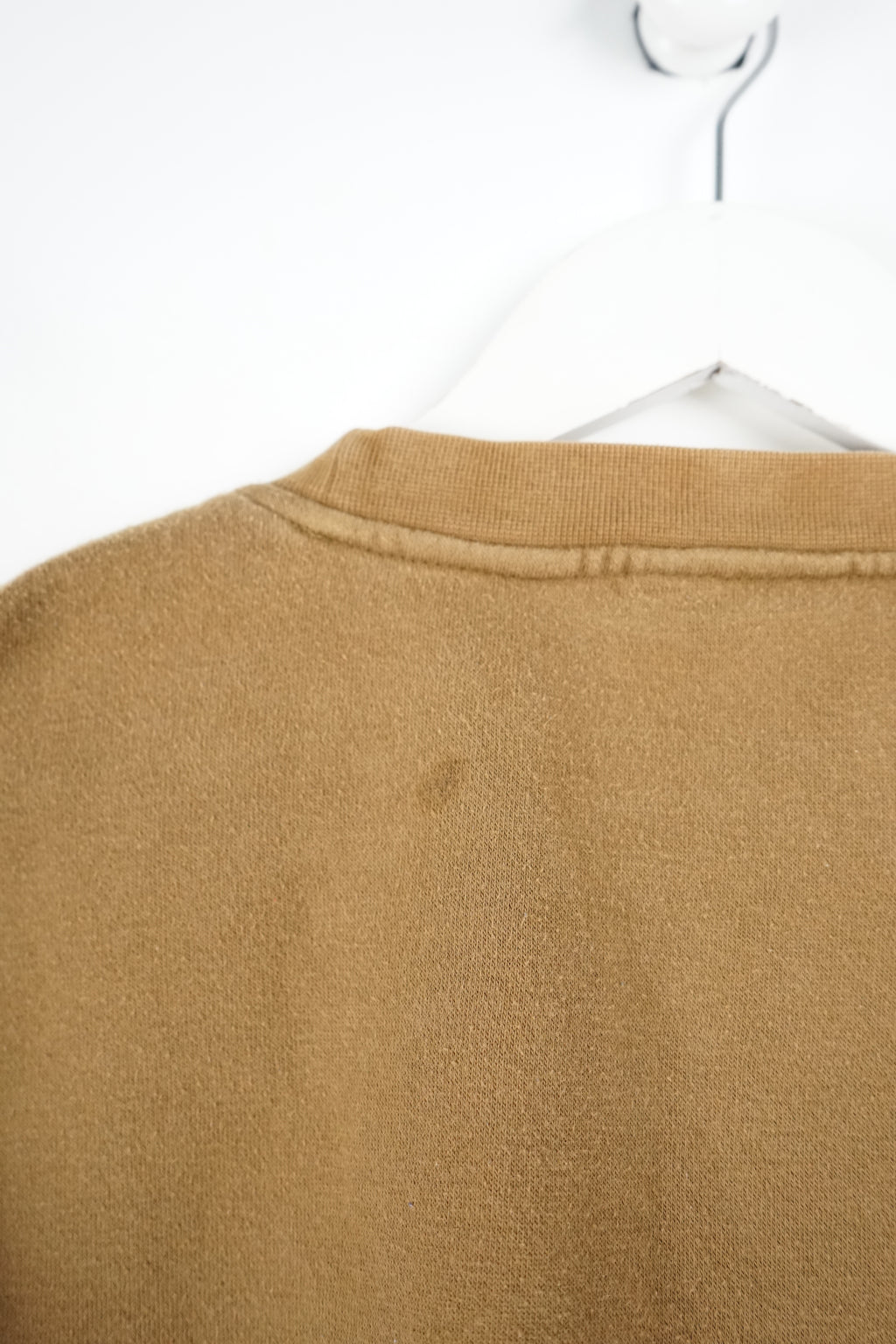 Brown sweatshirt with Fila logo on a white background
