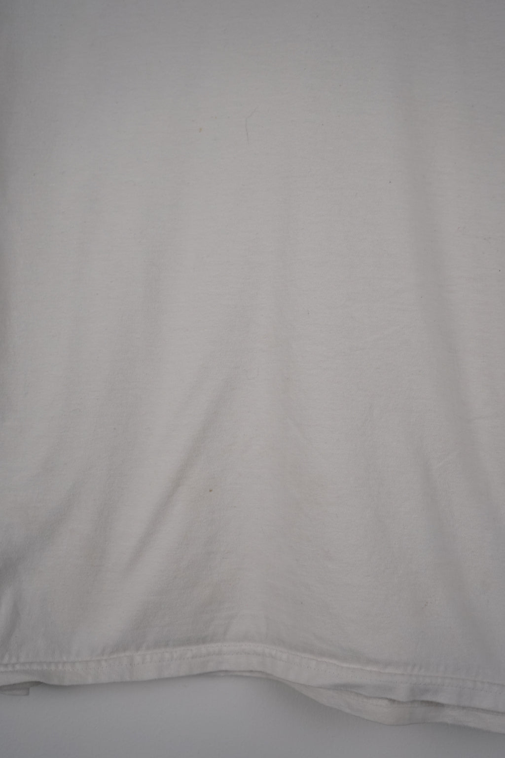 White long-sleeve shirt with navy collar on a white hanger against a white background