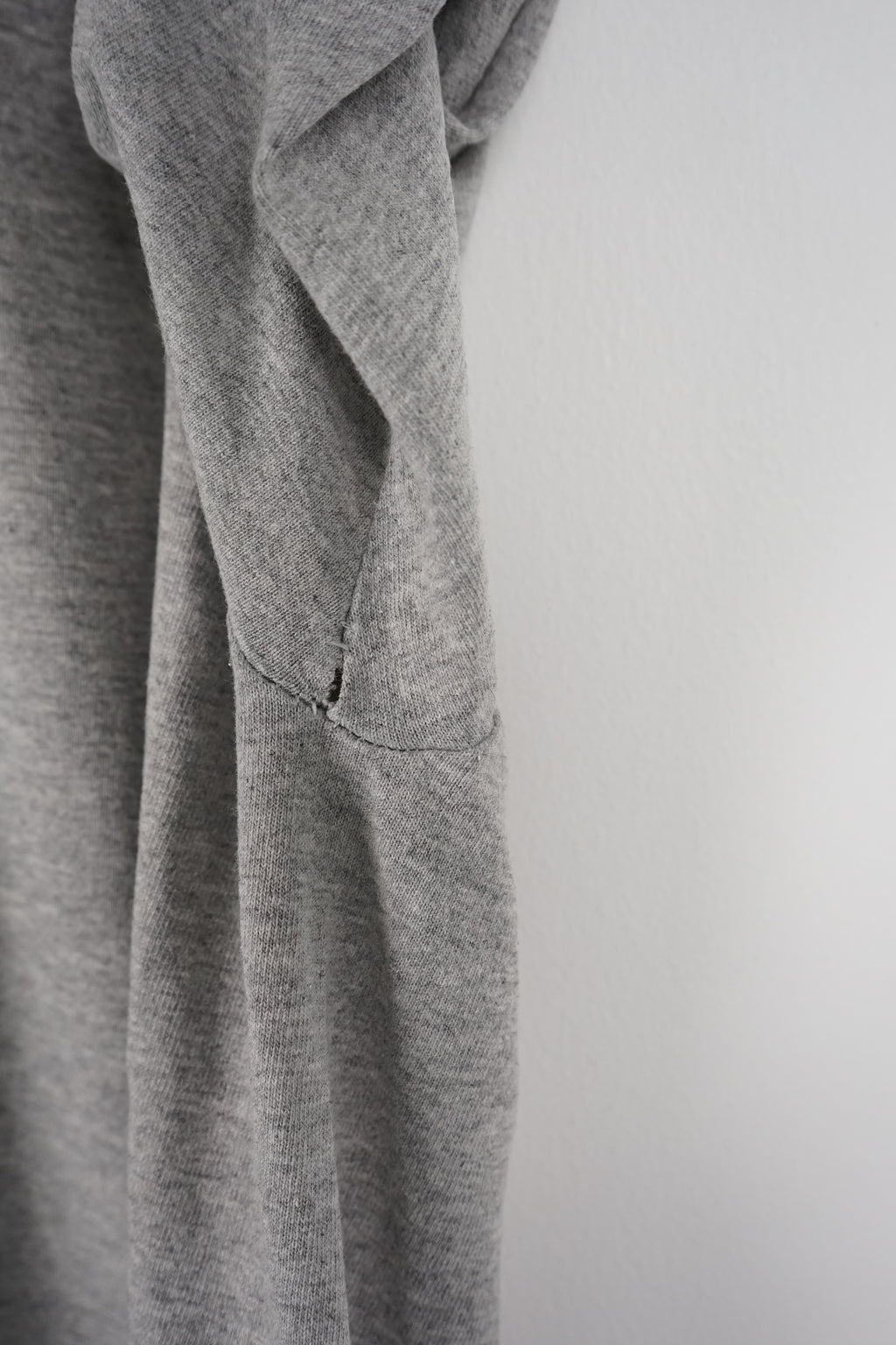 Gray t-shirt with Nebraska logo on a white background