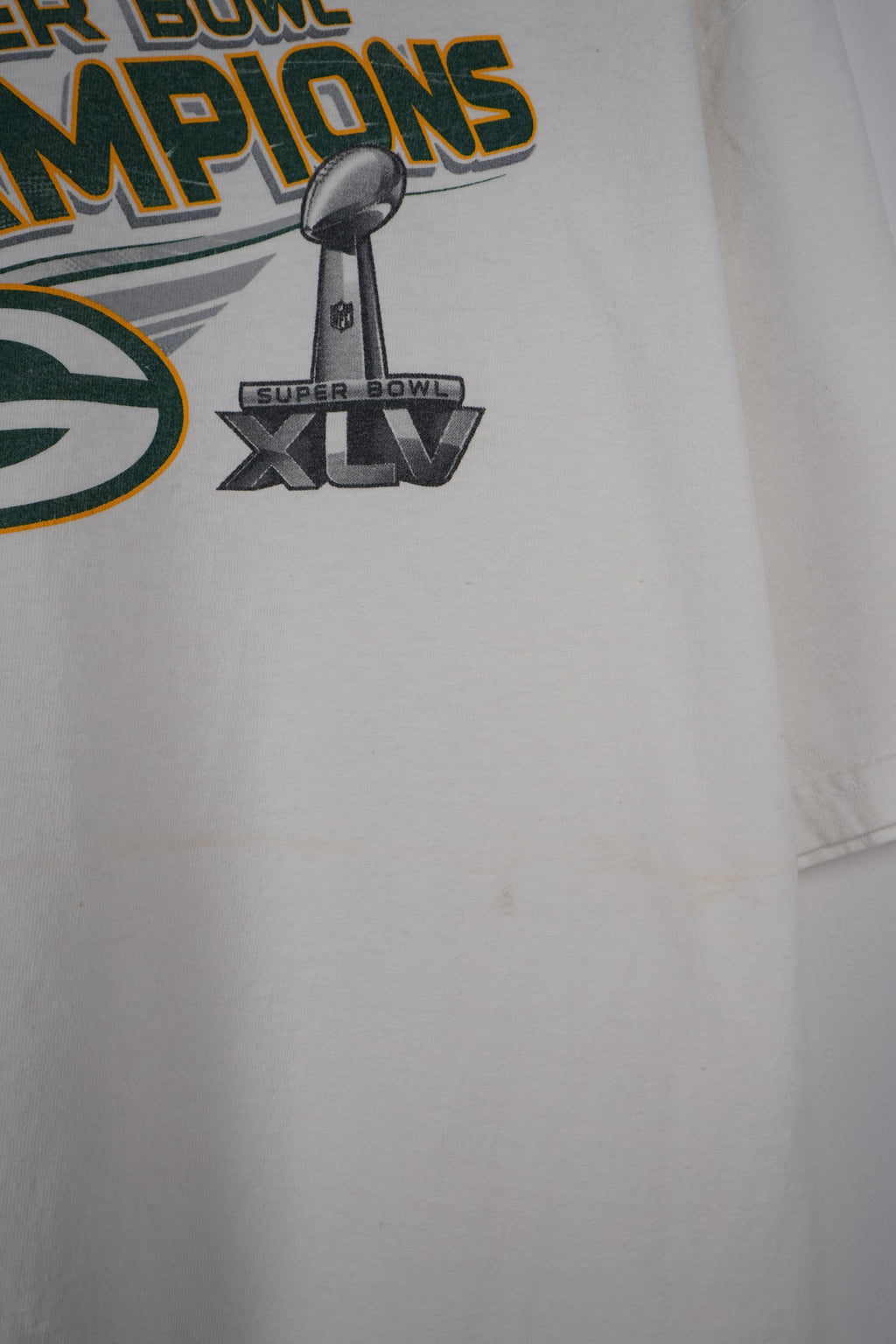 White t-shirt with Super Bowl Champions text and logo on a white background