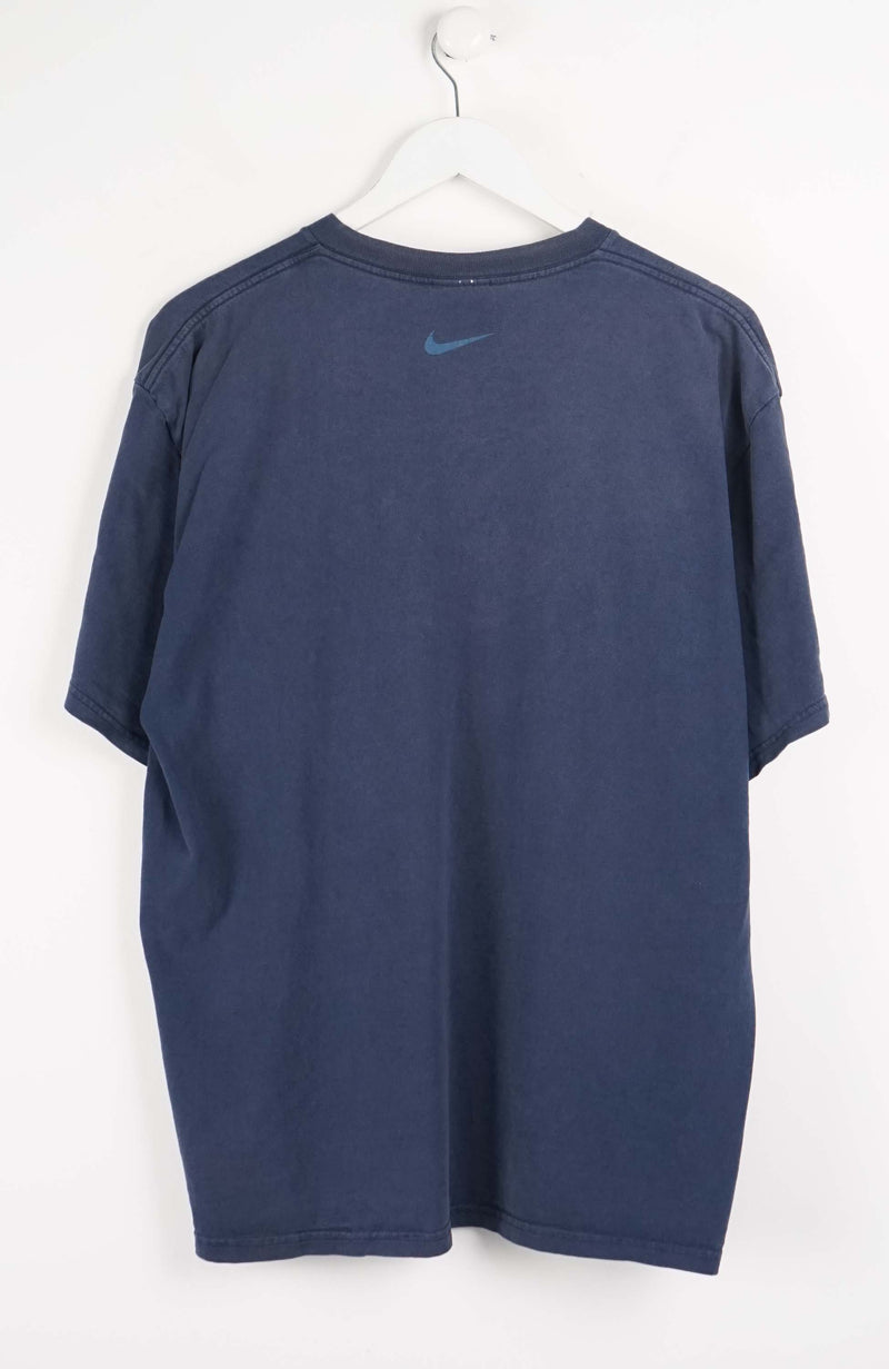 Blue t-shirt with Nike logo on a white background