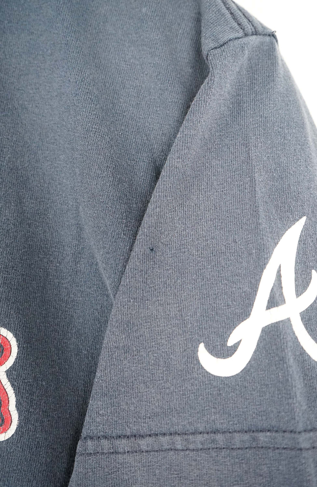 Navy blue t-shirt with Braves logo on a white hanger