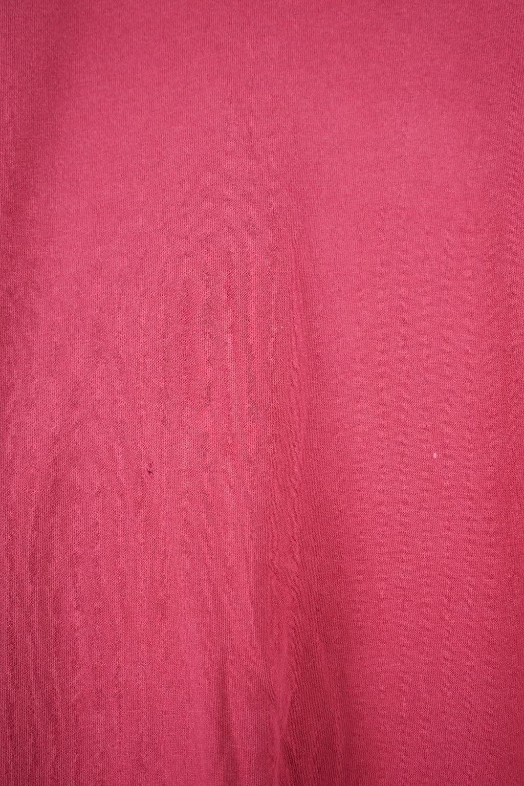 Red t-shirt with a Nike logo on a white hanger