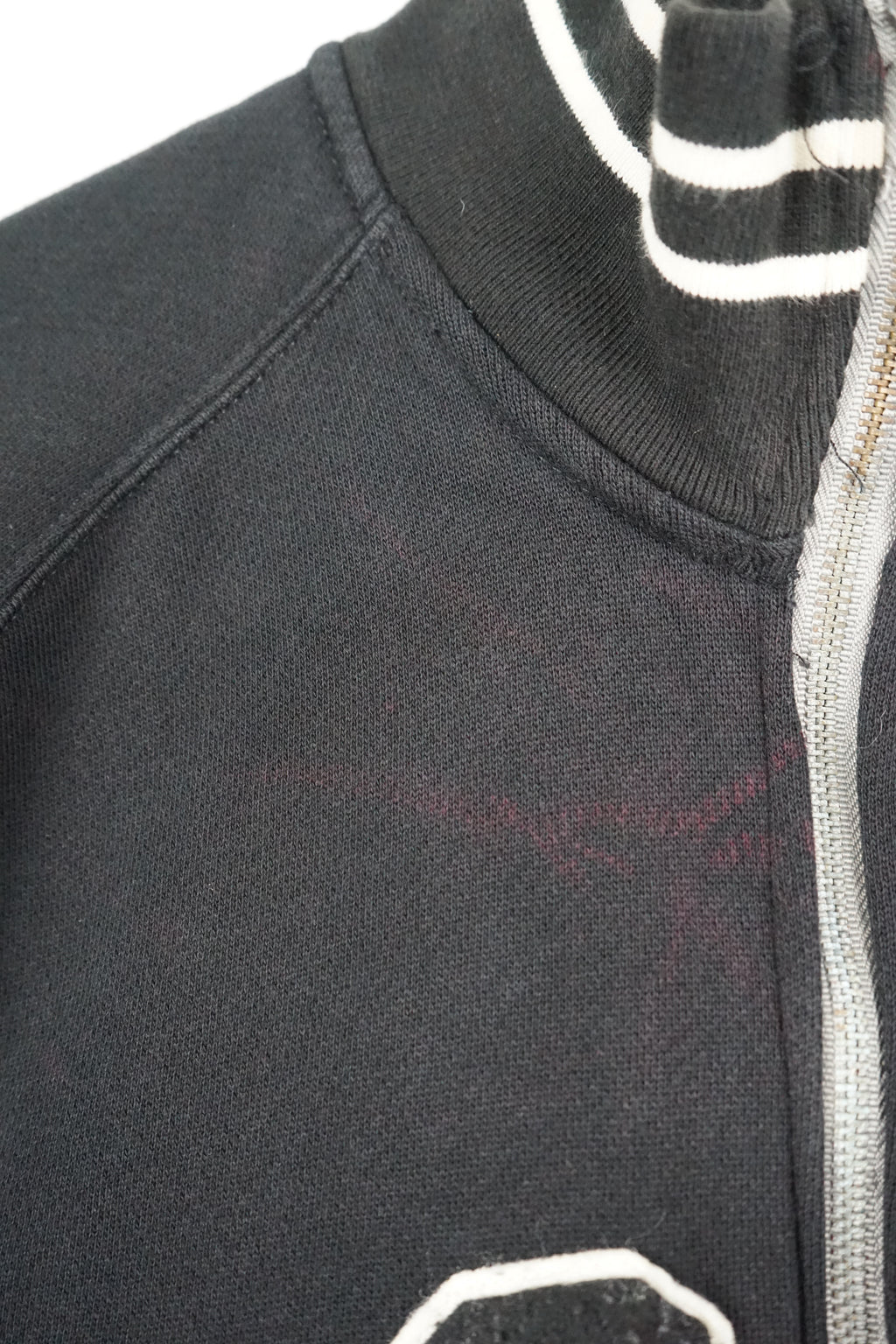 Black jacket with 'Polo' and number '67' on a white background